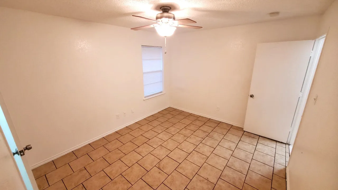 spacious master bedroom has own master bathroom and door towards access to the backyard.