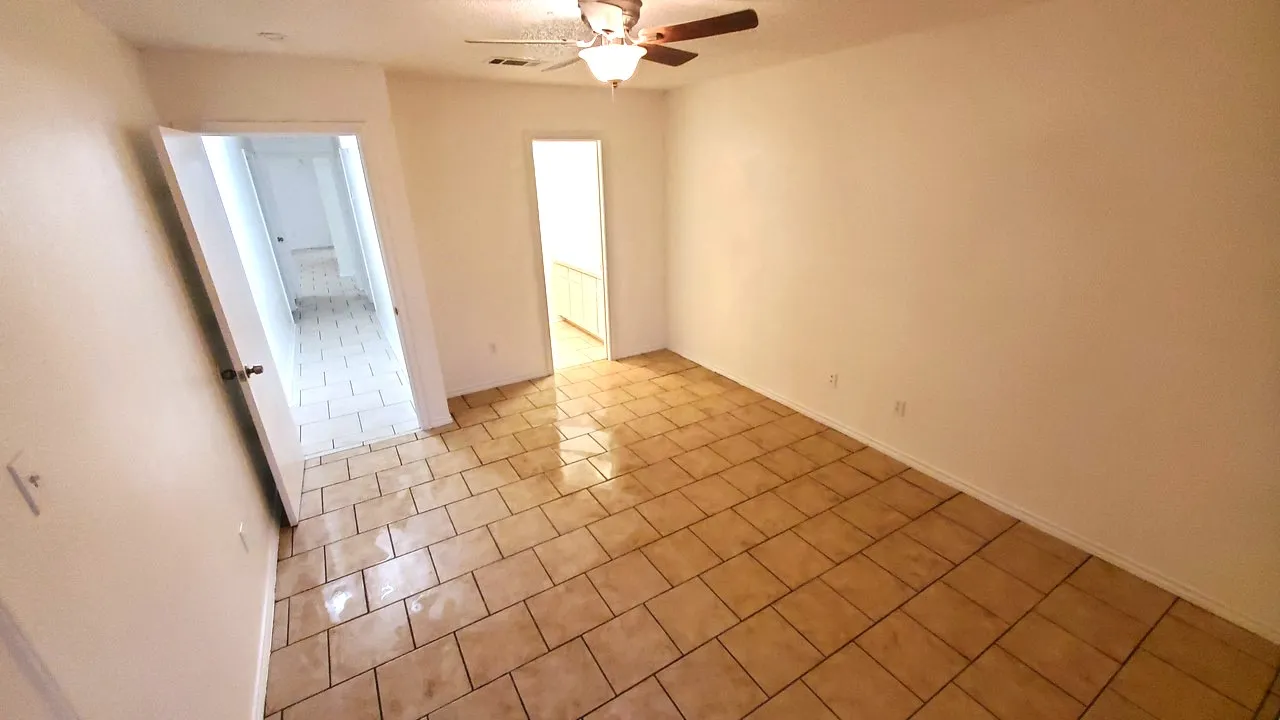 spacious master bedroom has own master bathroom and door towards access to the backyard.