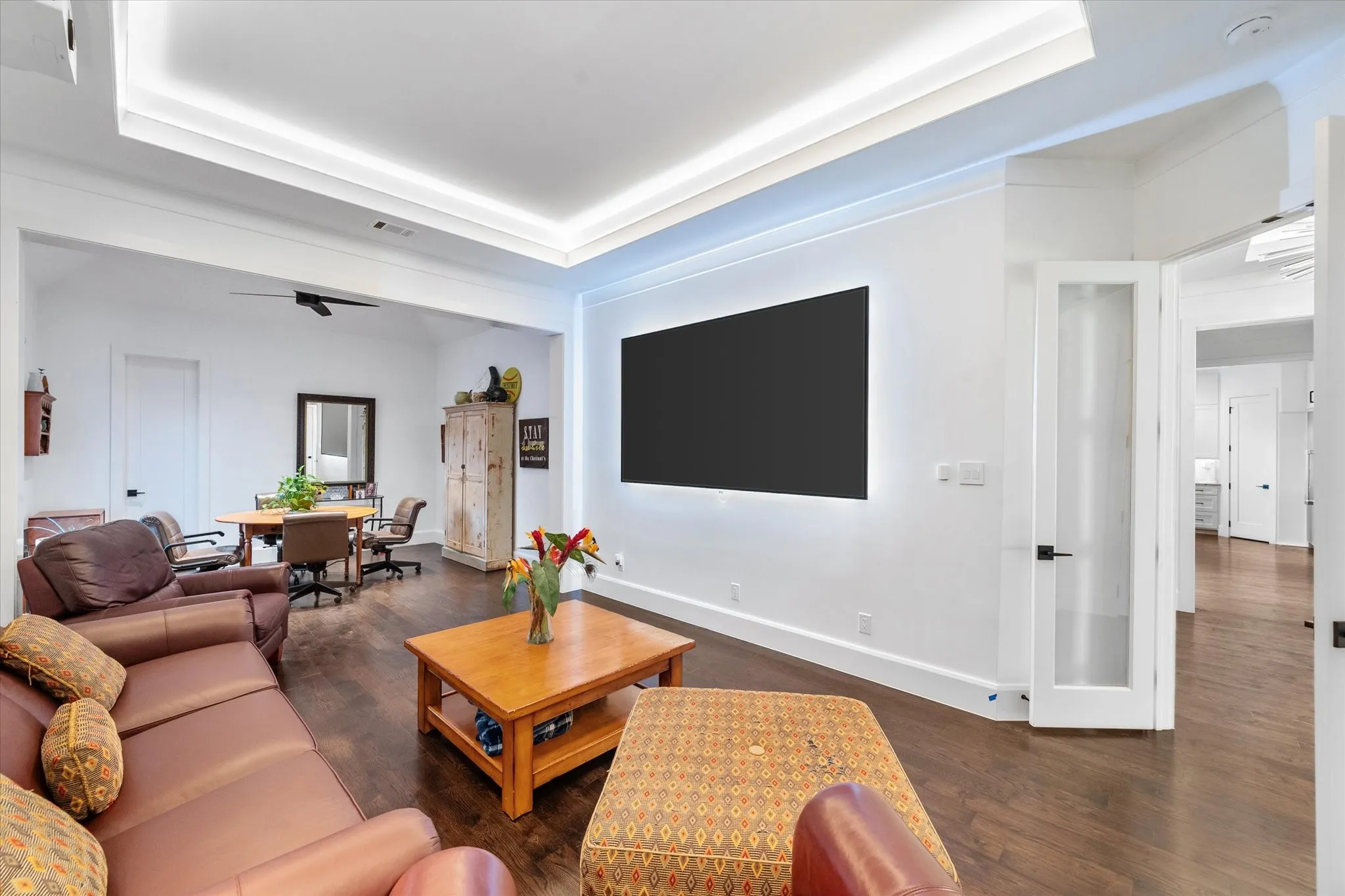 Open-concept living space featuring wood-finish flooring and recessed ceiling lighting
