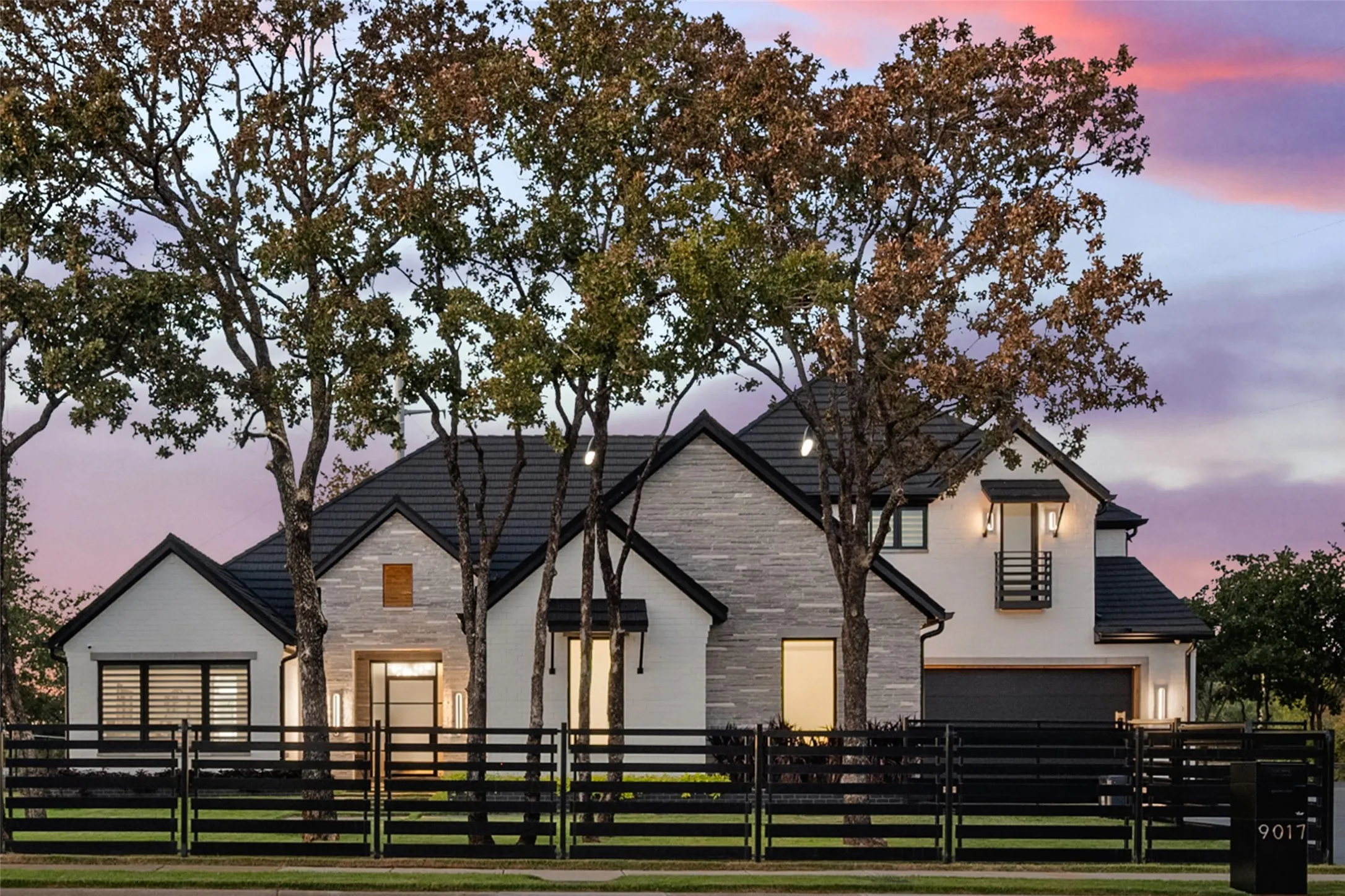 Contemporary residence featuring a blend of white brick and light-toned stacked stone