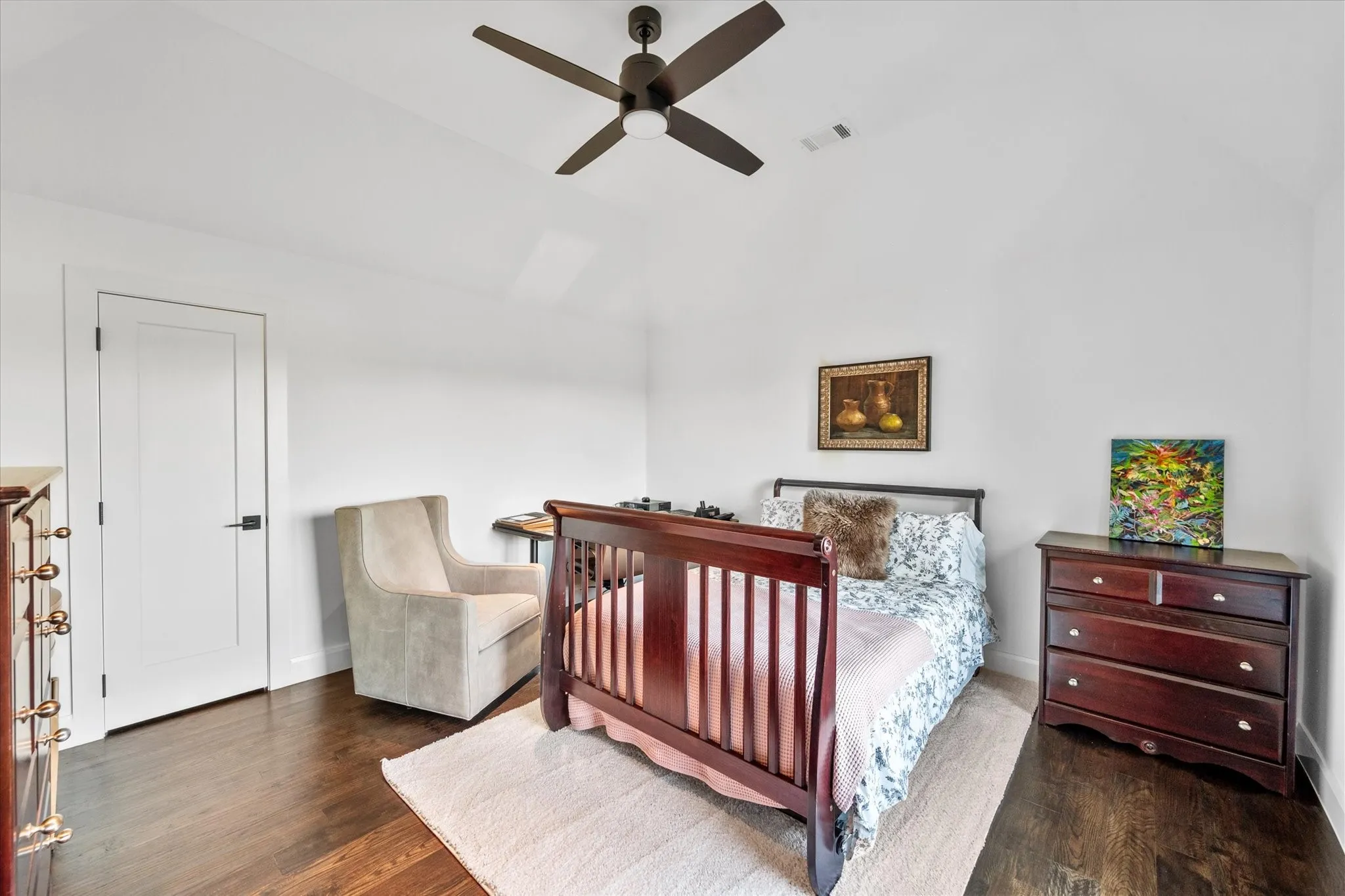 Room featuring high vaulted ceiling, dark wood-finish flooring, and a modern ceiling fan
