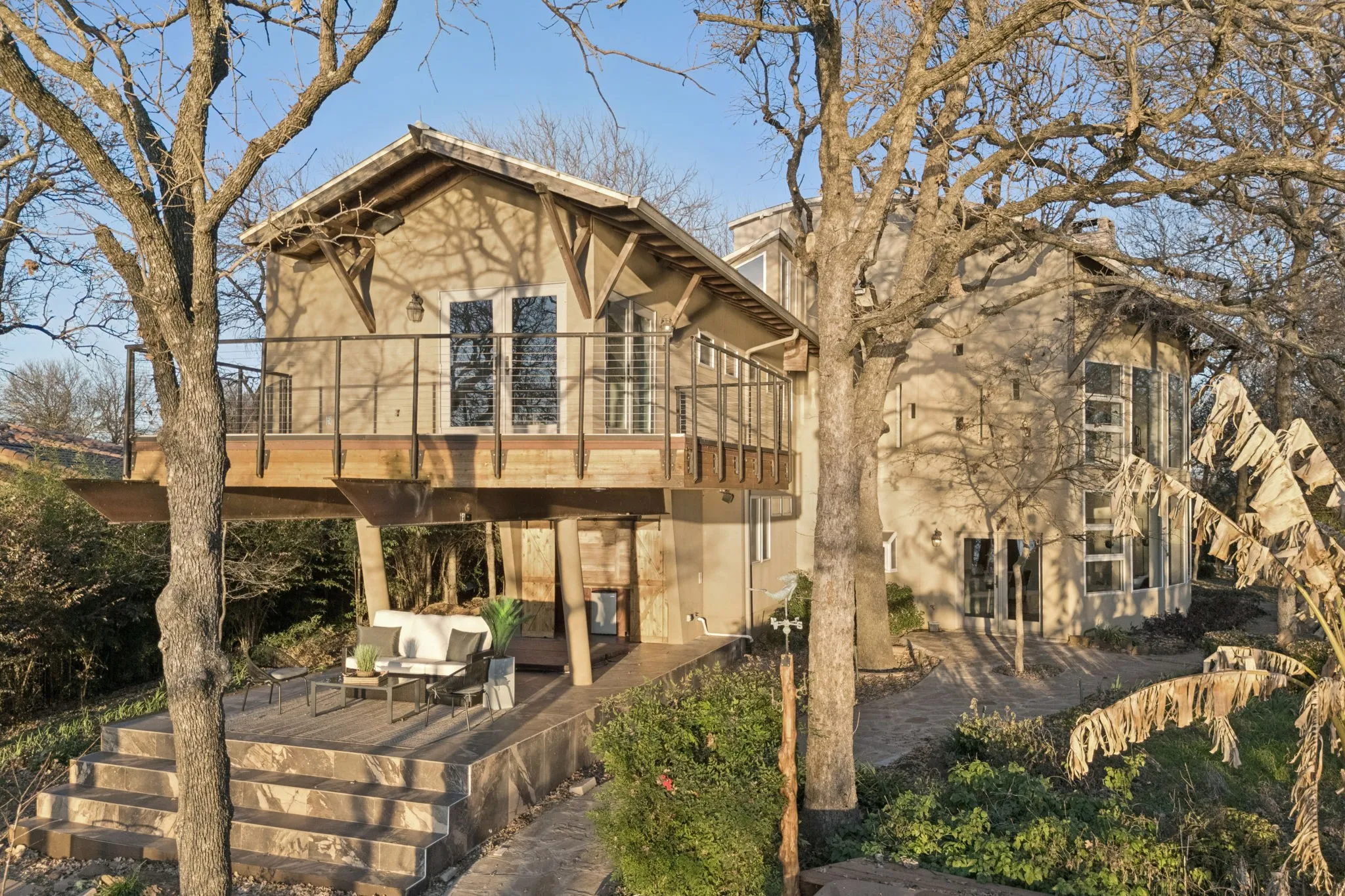 Rear view of house featuring stucco siding and a patio area