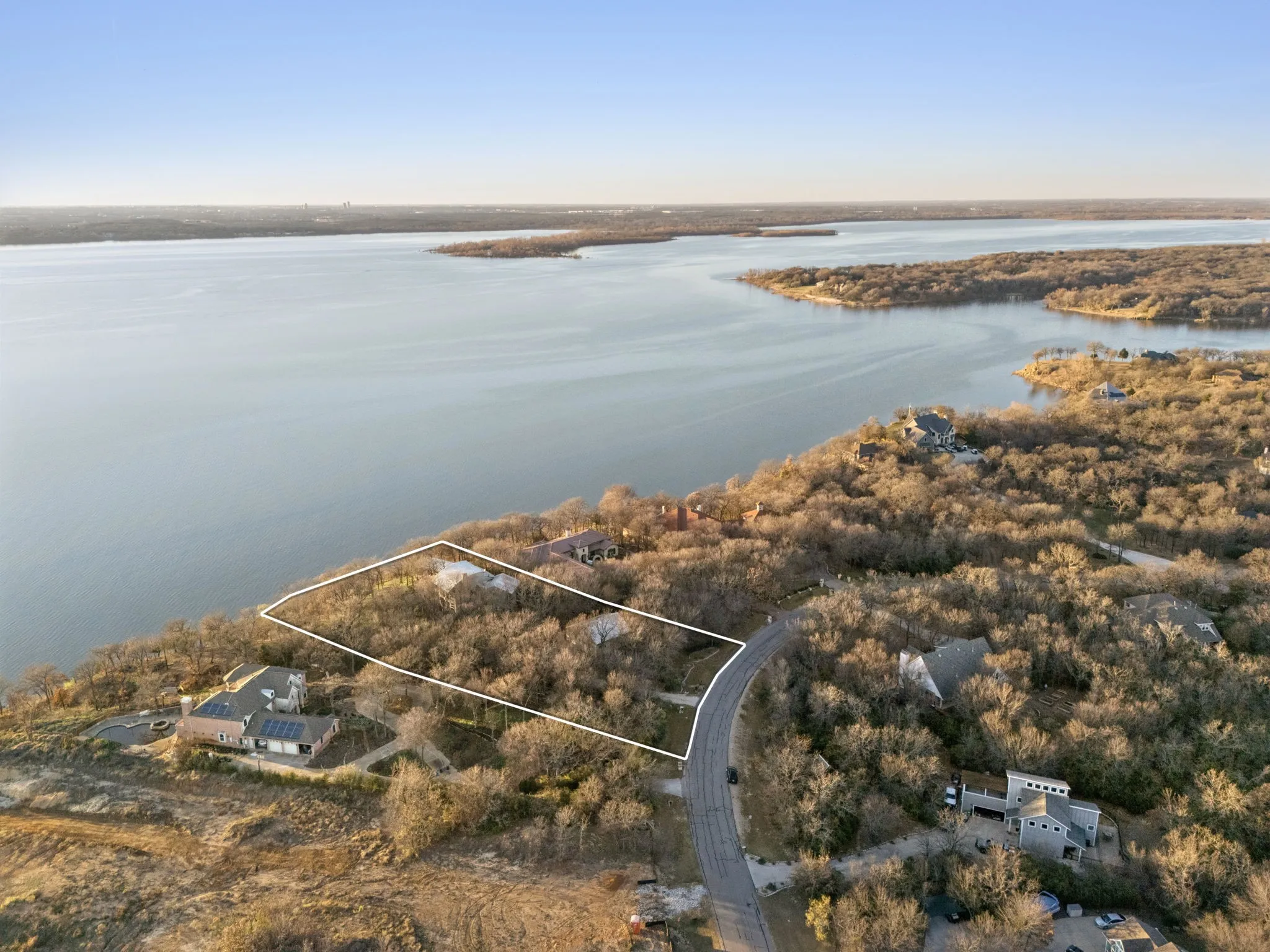 Aerial view of property's location with property boundaries highlighted and a nearby body of water