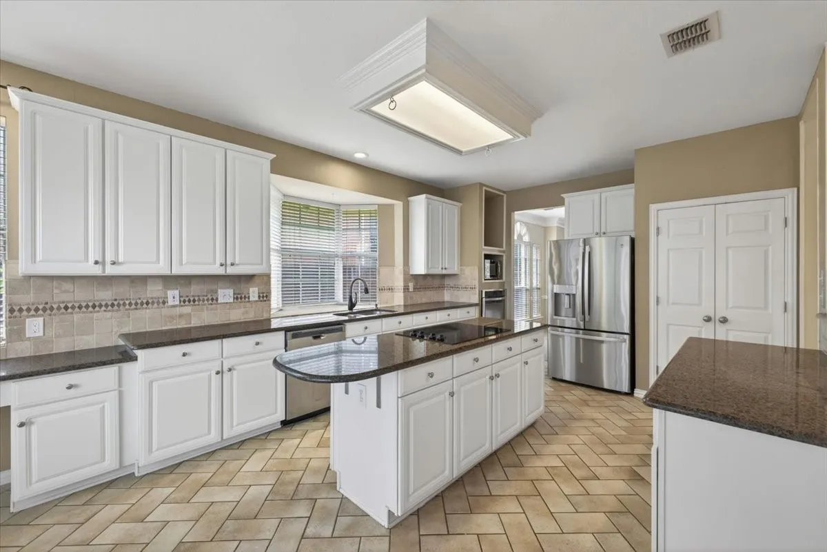 Functional kitchen with convenient access to the home's spacious living and dining areas.
