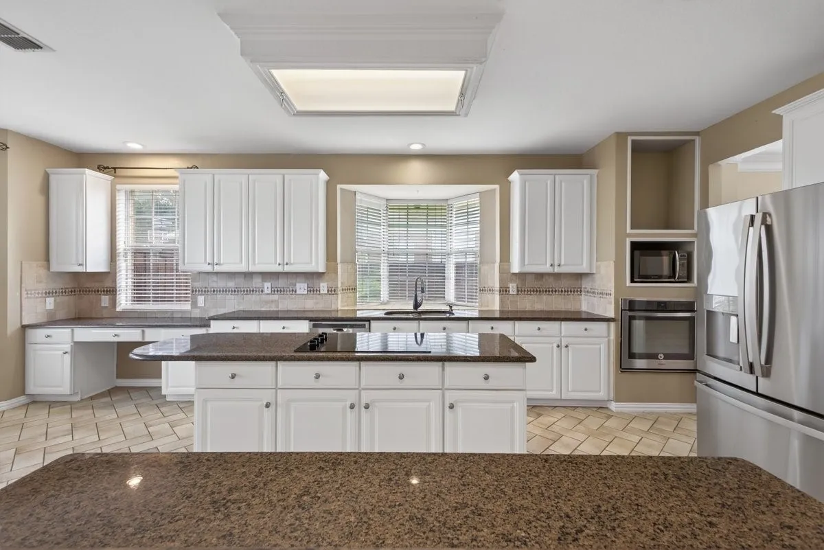 Functional kitchen with convenient access to the home's spacious living and dining areas.