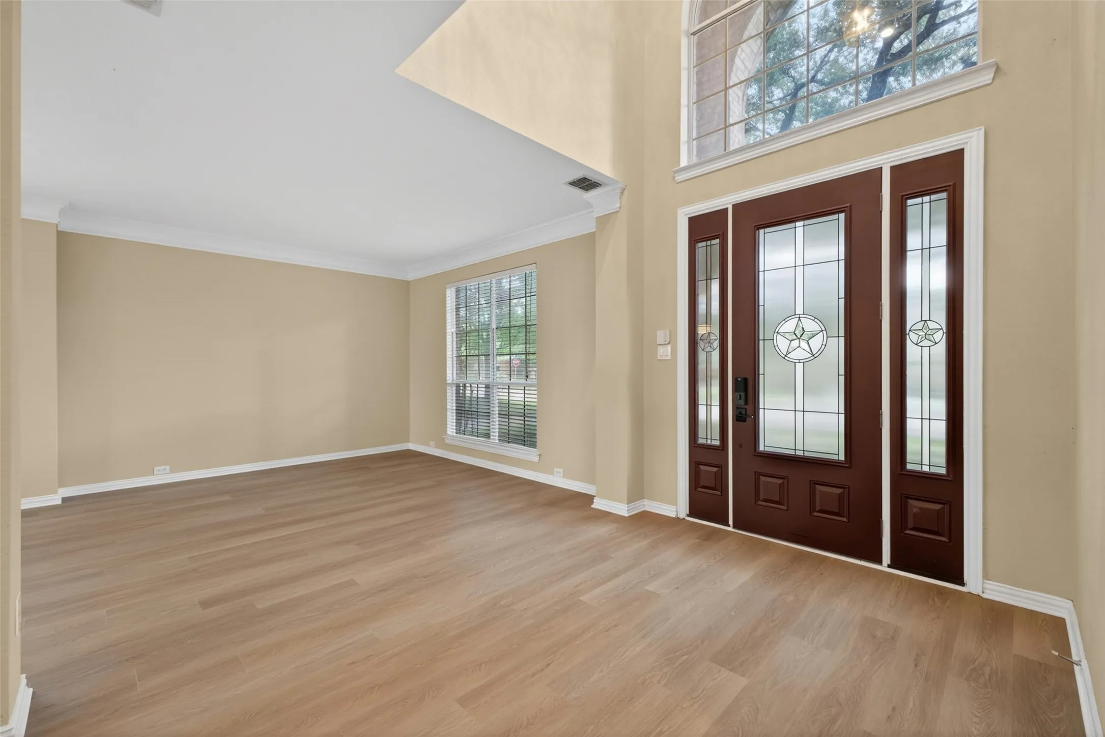 Welcoming entry with updated front door, stylish lighting, and fresh flooring.