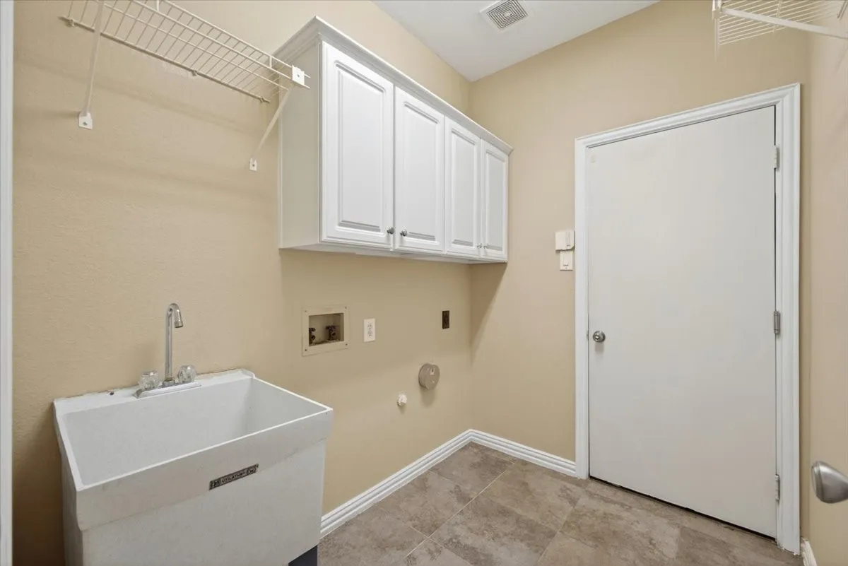Laundry room with wash sink.