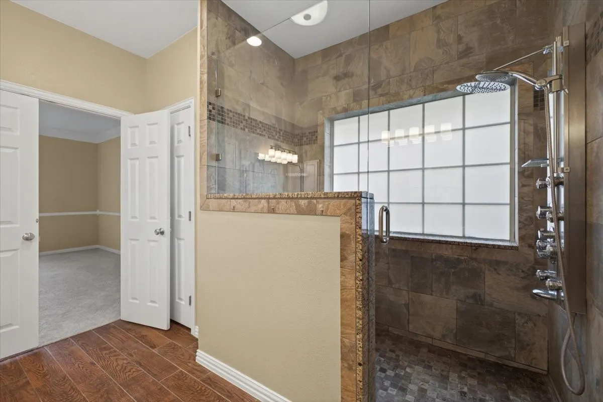 Private primary bathroom offering a comfortable and functional layout.