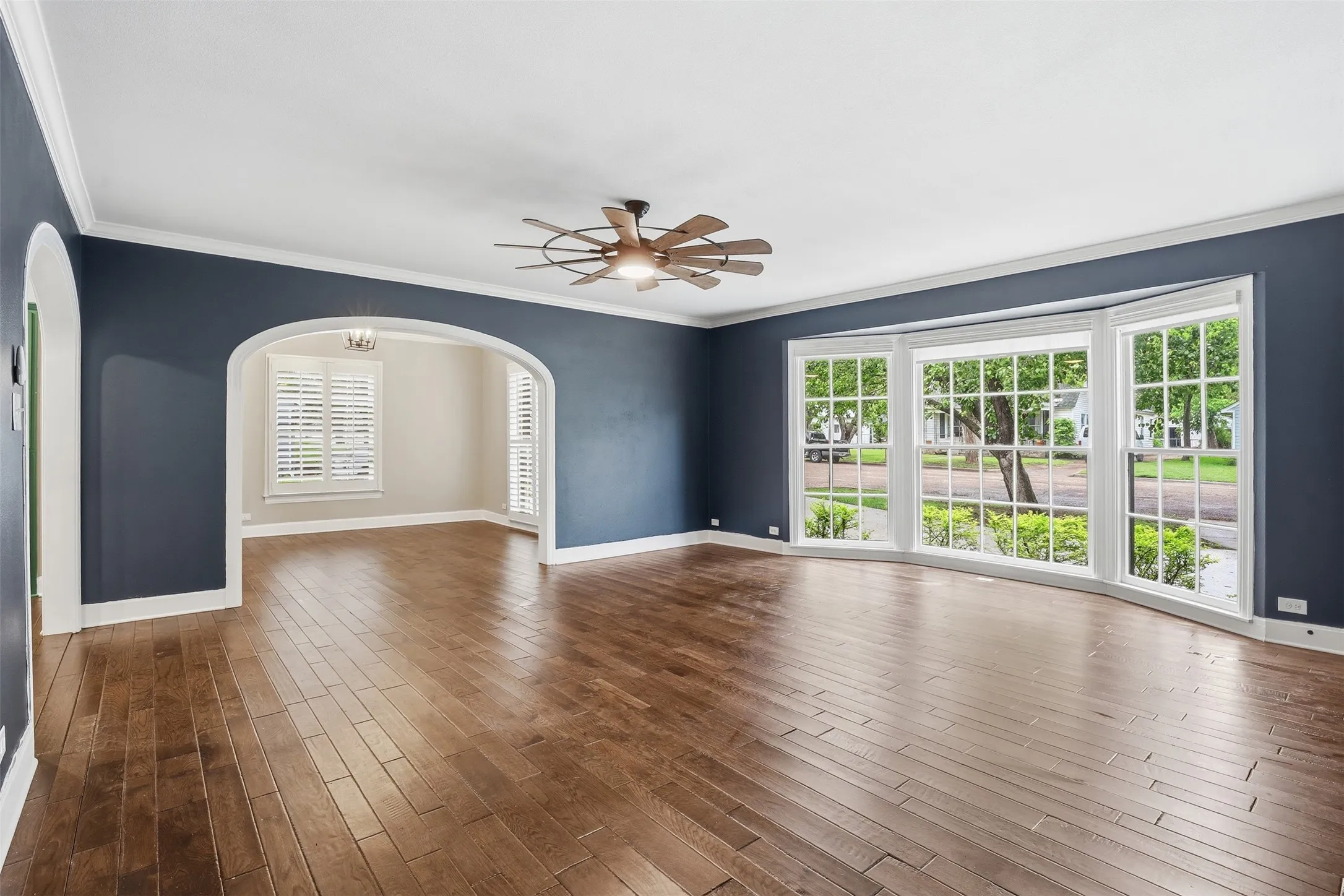 Showing large open concept living area with wood floors, leading into kitchen and dining room. Picture perfect space to call home.