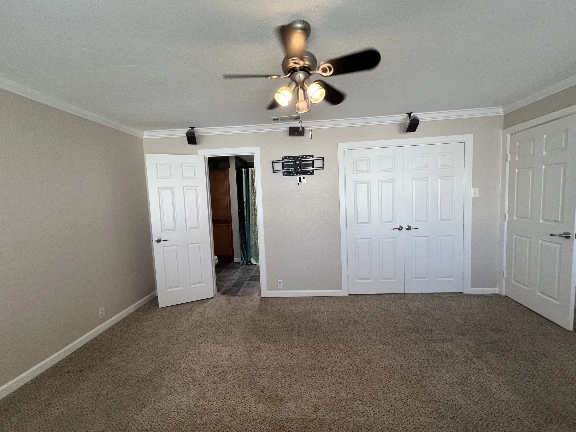 Neutral-toned carpeting throughout bedroom floor.