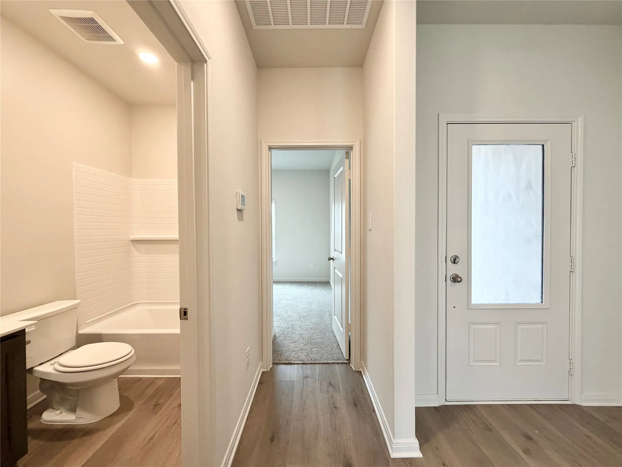 Corridor to front bedroom and full bathroom in the front of the house