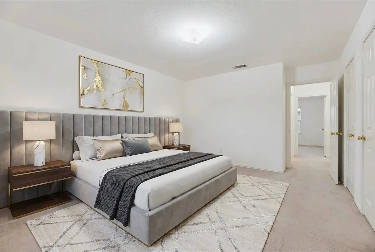 Carpeted room featuring neutral wall tones, multiple doorways, and a flush-mount ceiling light fixture