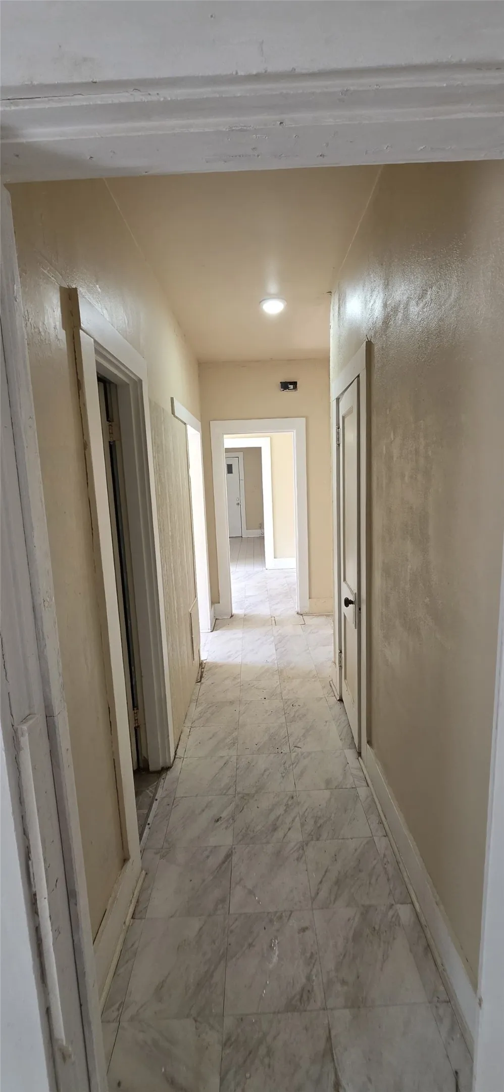 Hallway featuring recessed lighting, light-toned walls, and tile flooring