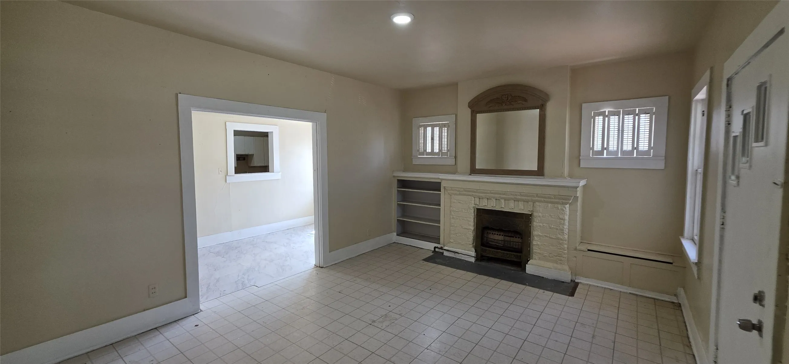 Living area featuring a prominent fireplace with a decorative mantel and hearth