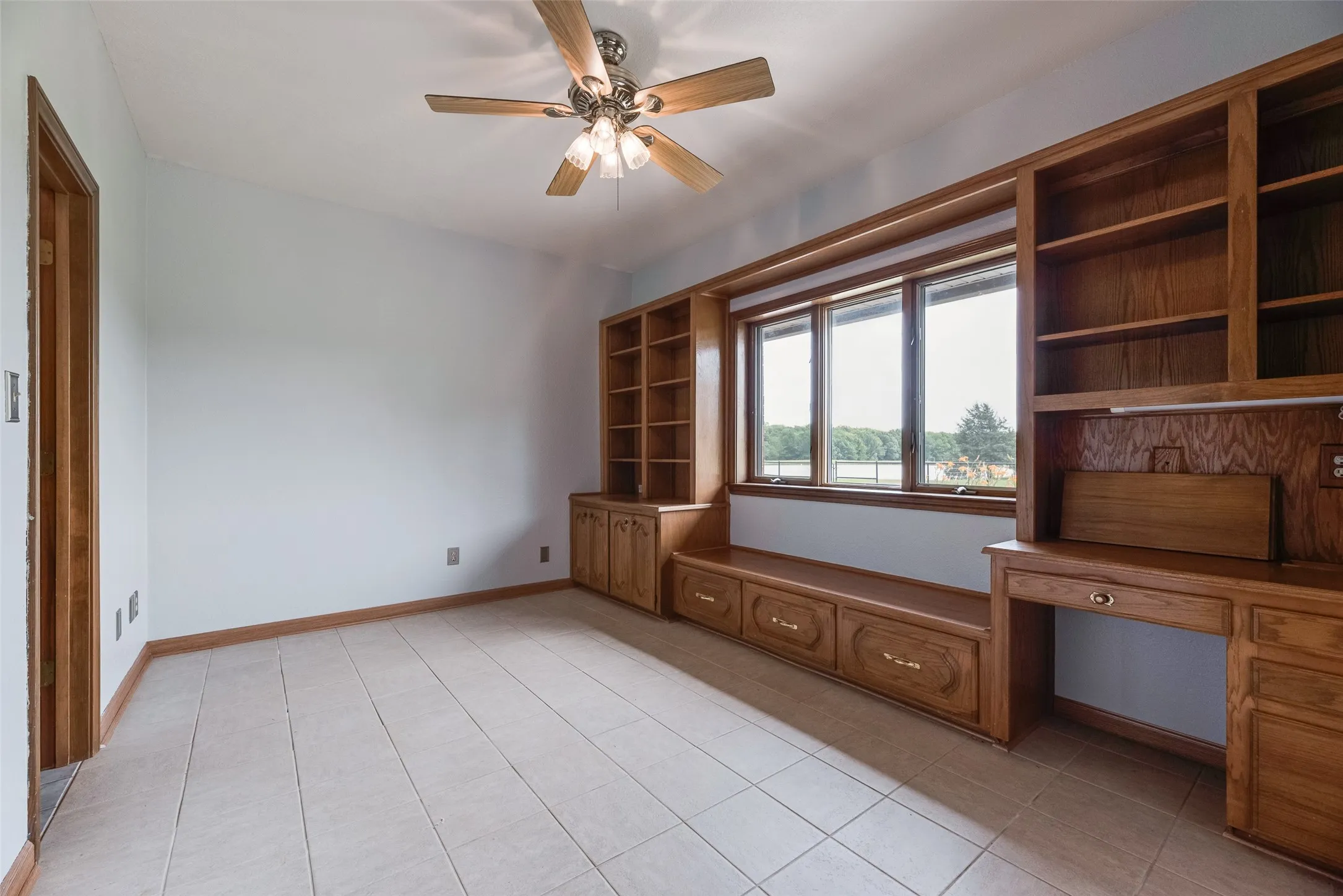 Office space with pasture views and built-in shelving.