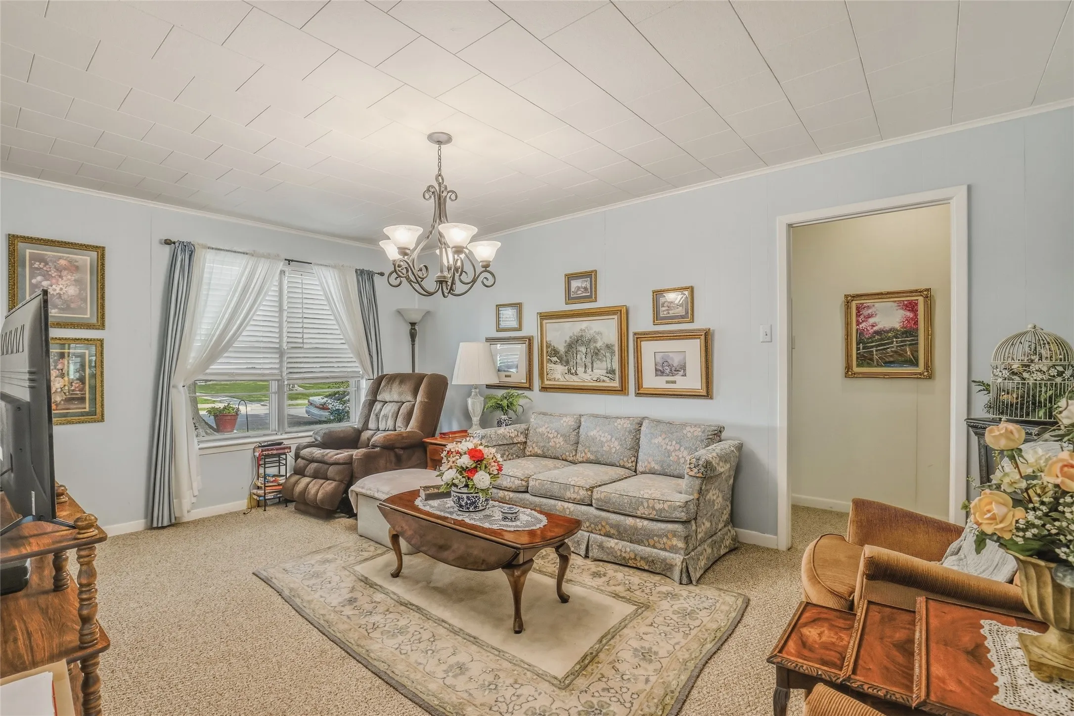 Inviting living area featuring light blue walls and textured ceiling