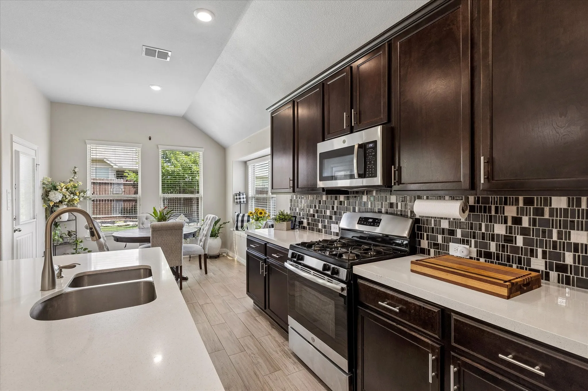 Tiled backsplash, double sinks and a built in microwave