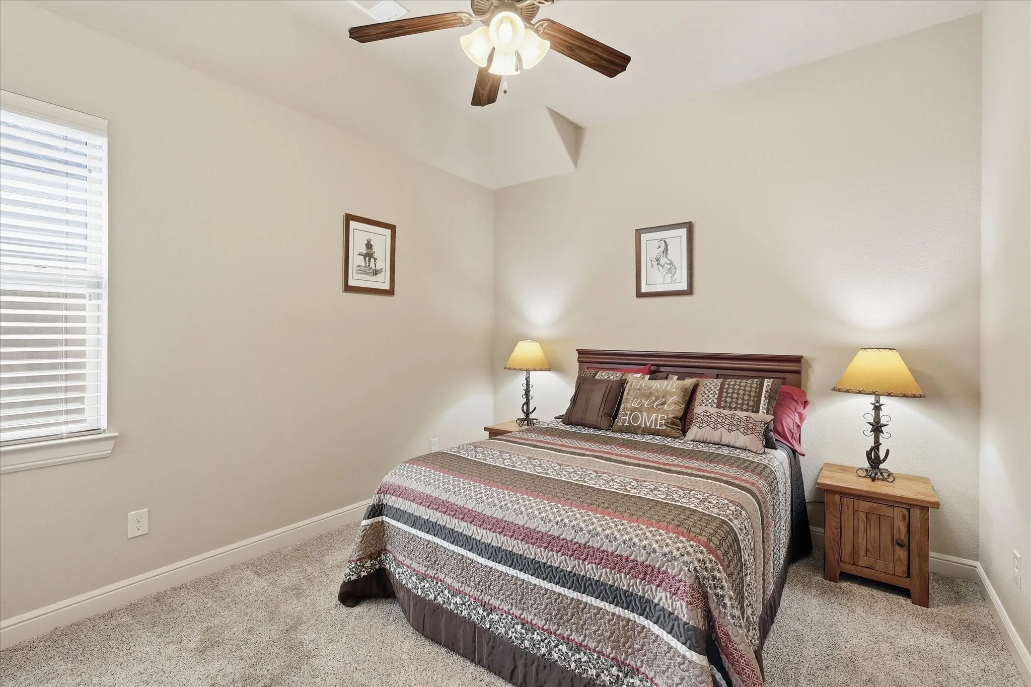Carpeted room featuring a ceiling fan, window with blinds, and neutral wall tones