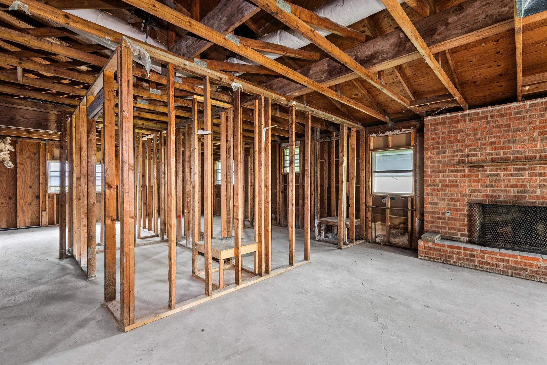 Interior framing visible with exposed ceiling joists and subflooring