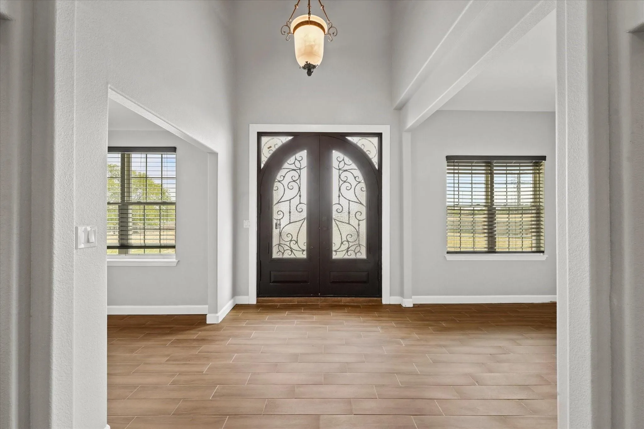 Double arched entry doors with decorative ironwork