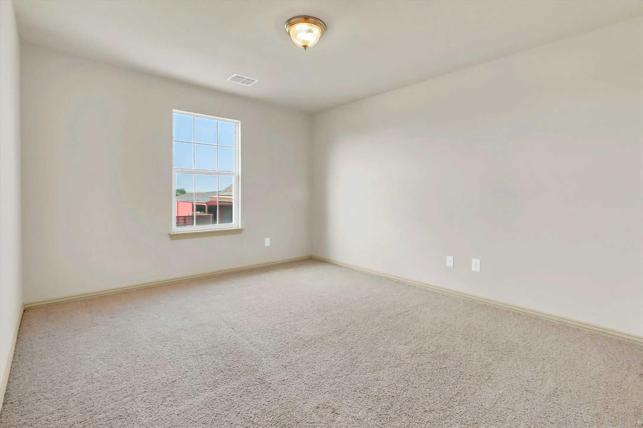 Carpeted room with neutral wall tones and white trim