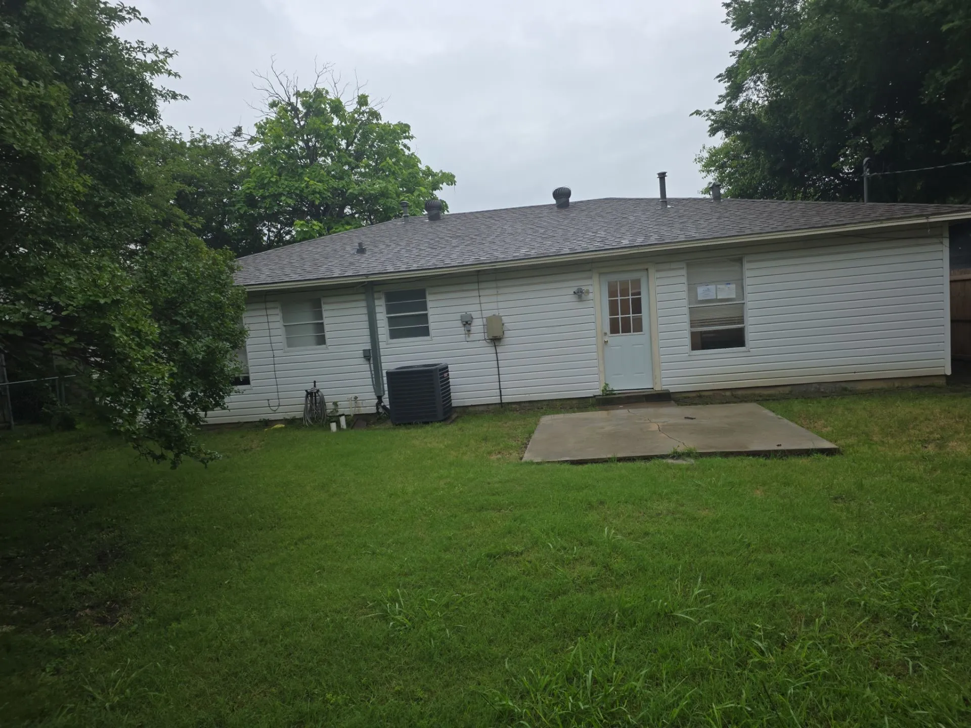 Rear exterior with white vinyl siding