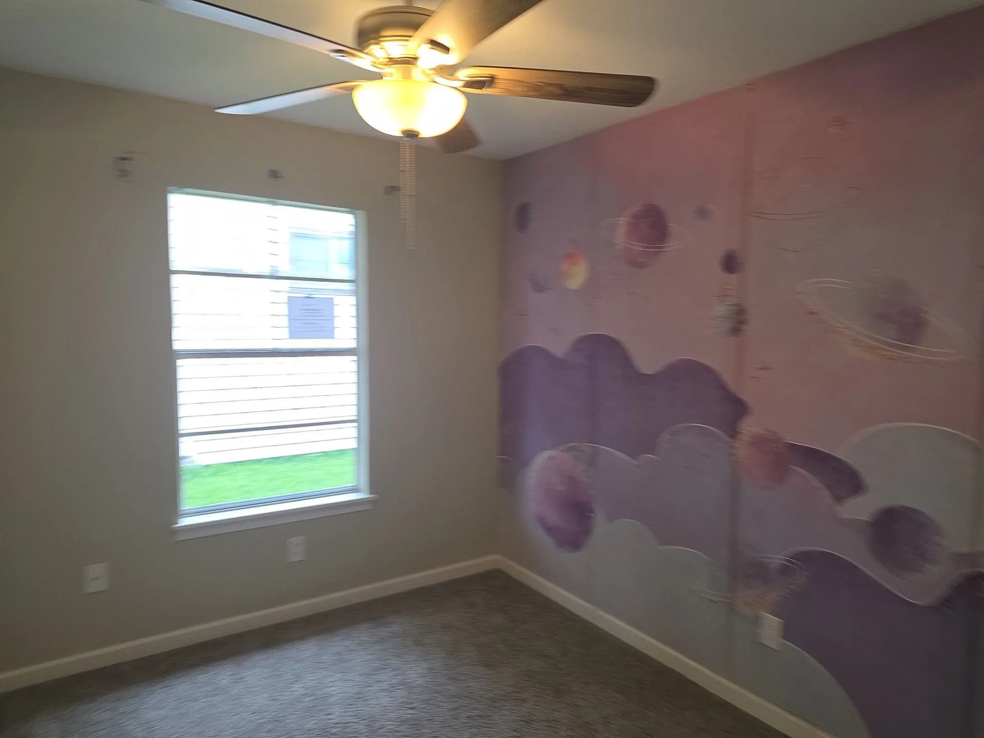 Room with ceiling fan light fixture, carpeted flooring, and a single window with horizontal blinds