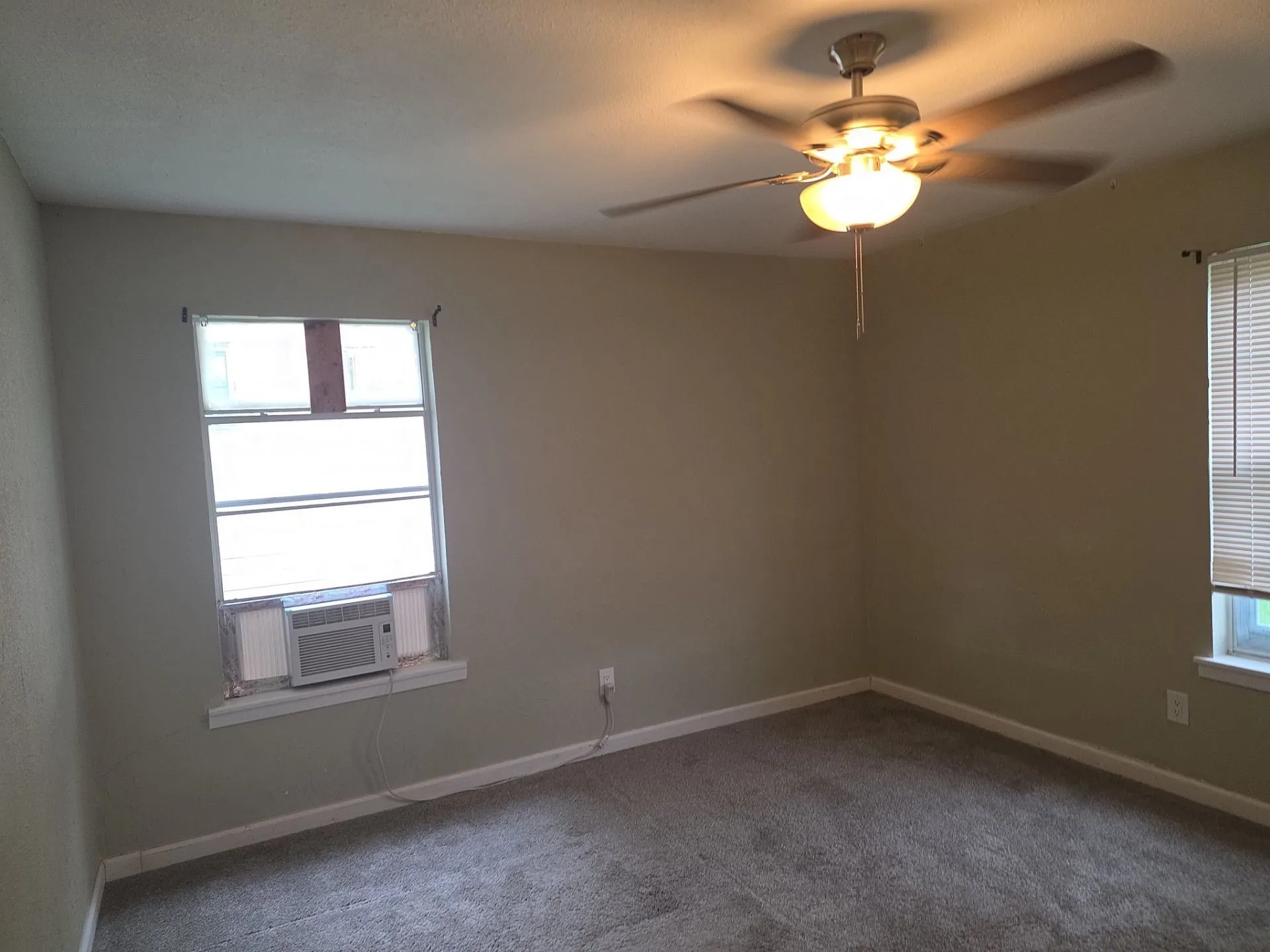 Neutral-toned walls complement the gray carpeting