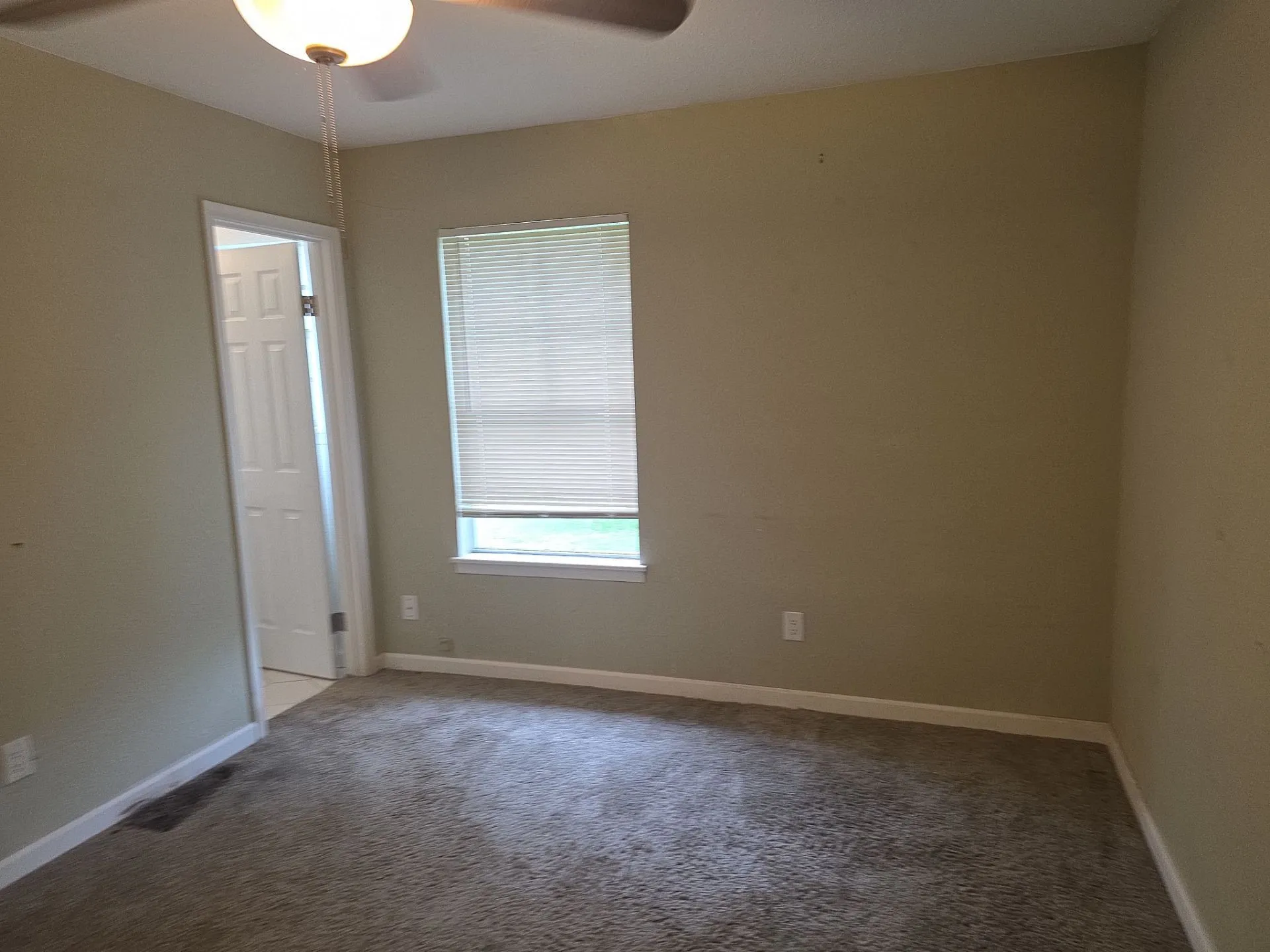 Carpeted interior space with neutral wall tones