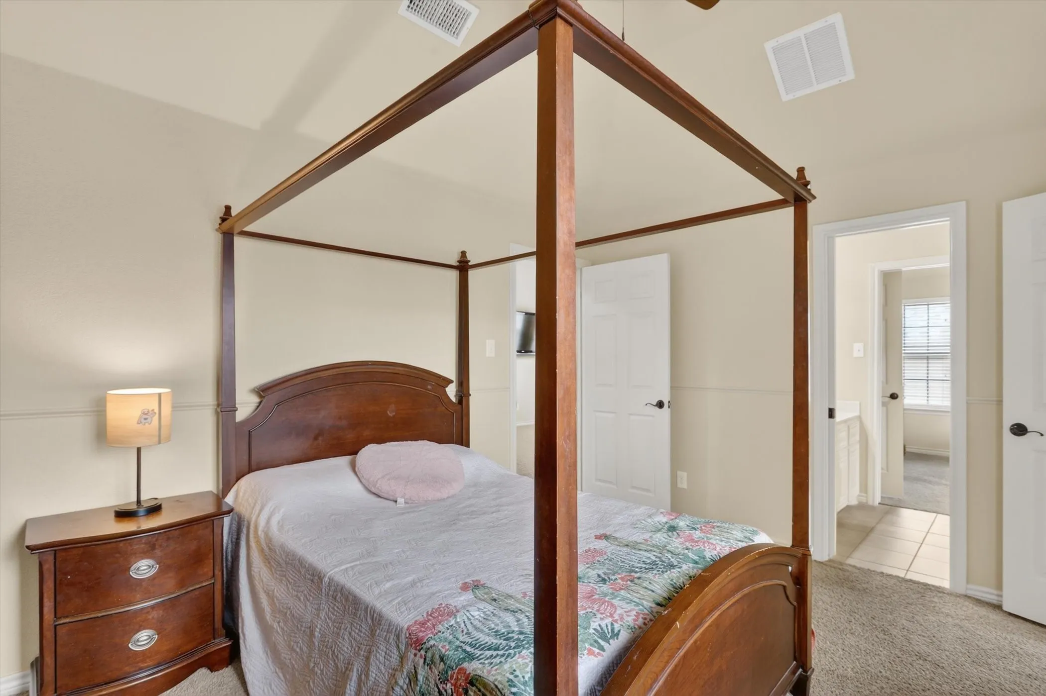 Bedroom 3 upstairs featuring light neutral wall colors, textured carpet flooring, and a vaulted ceiling