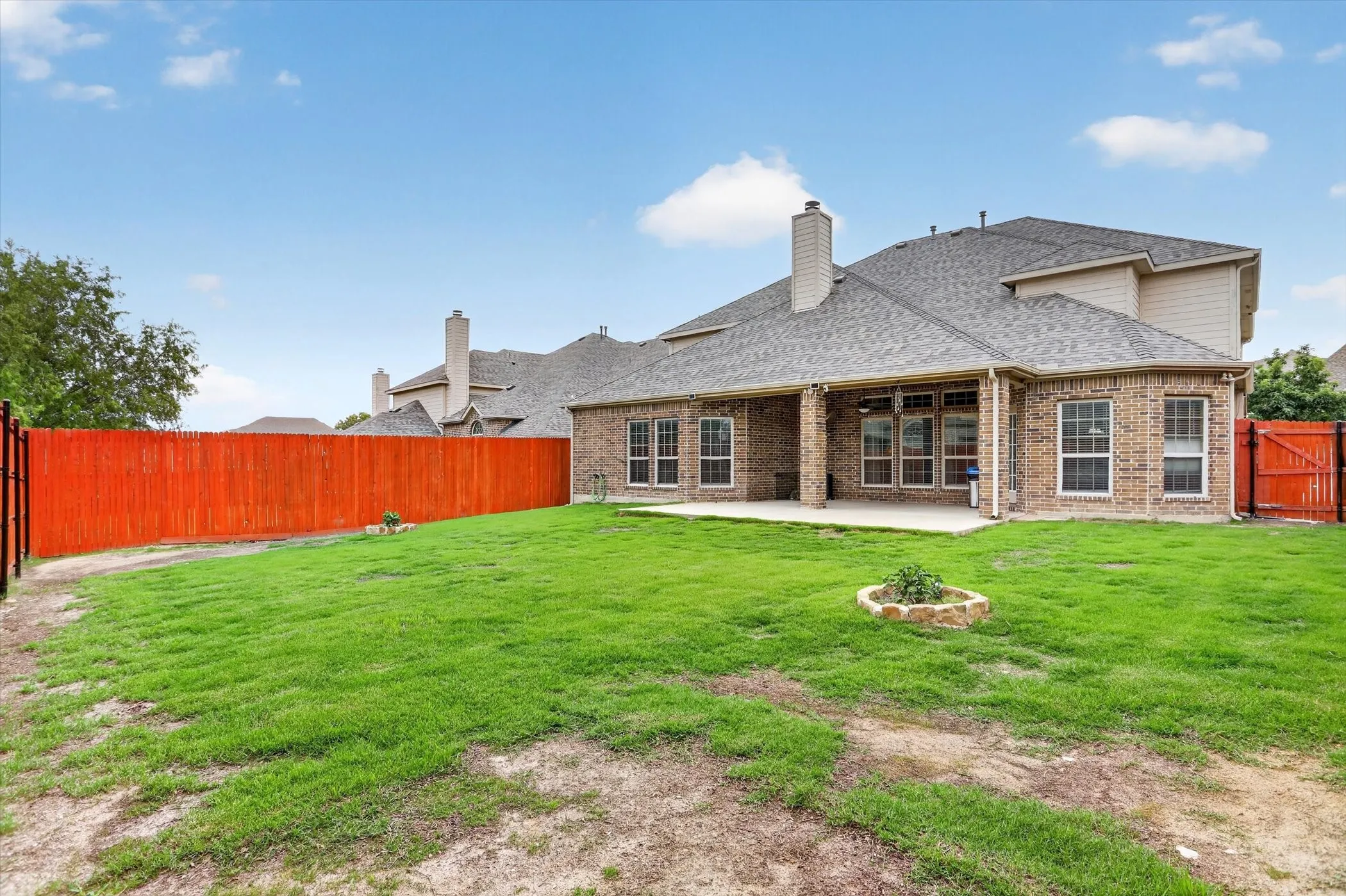 Expansive backyard with covered patio an extended patio slab.