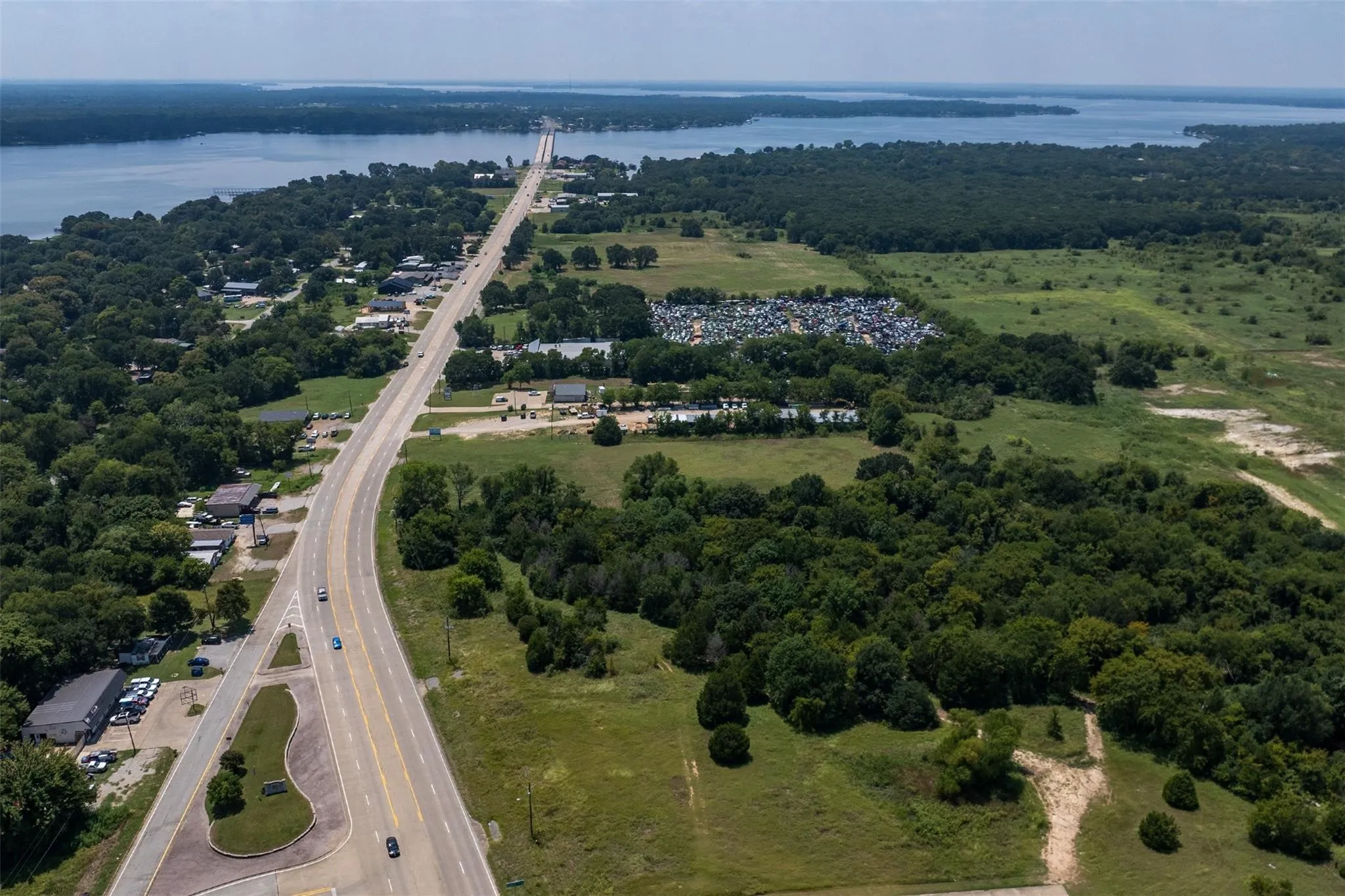 Aerial perspective showcasing a major roadway traversing a diverse​​‌​​​​‌​​‌‌​‌‌​​​‌‌​‌​‌​‌​​​‌​​ landscape
