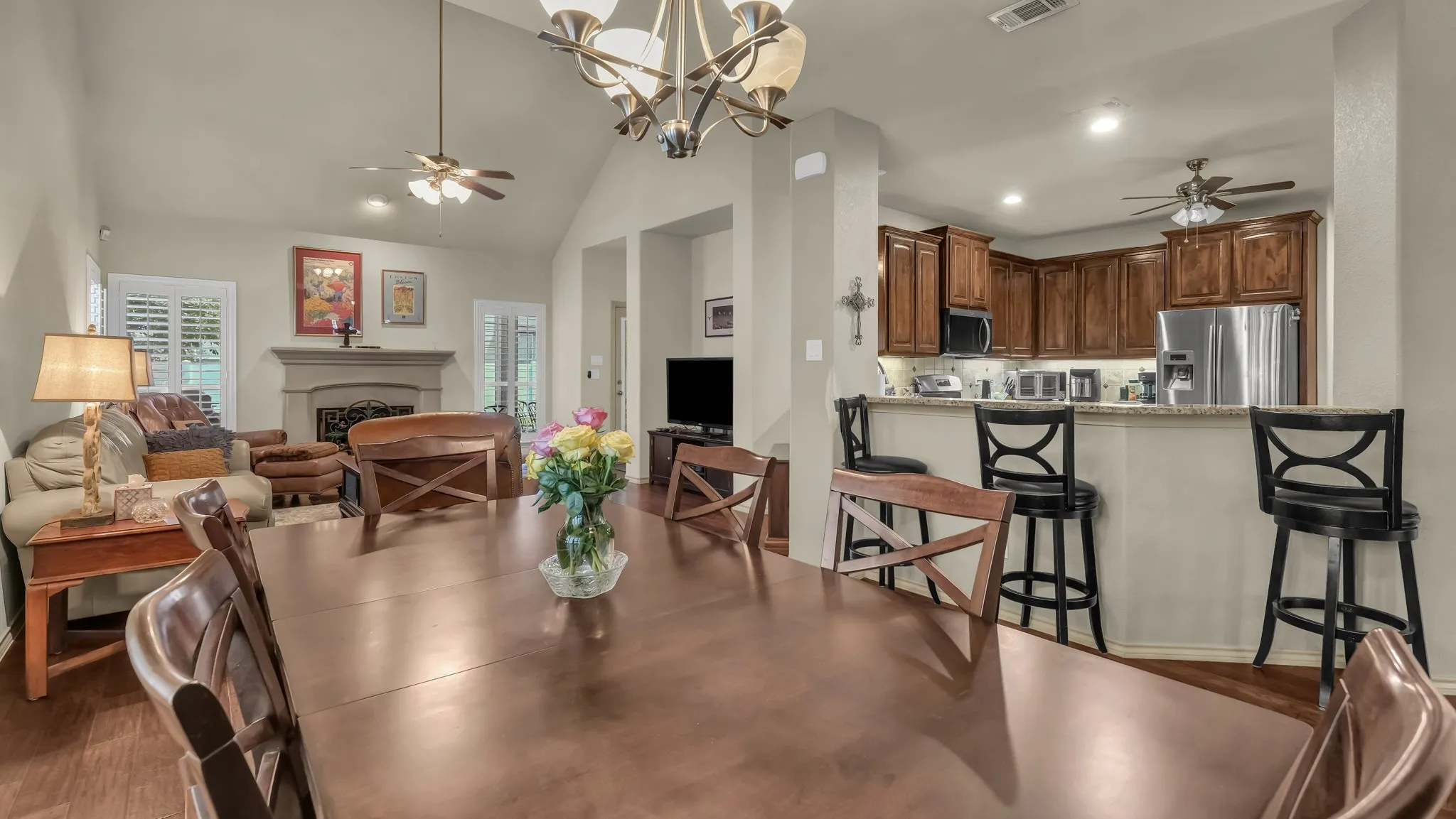 Spacious dining area featuring wood-finish flooring and a decorative chandelier