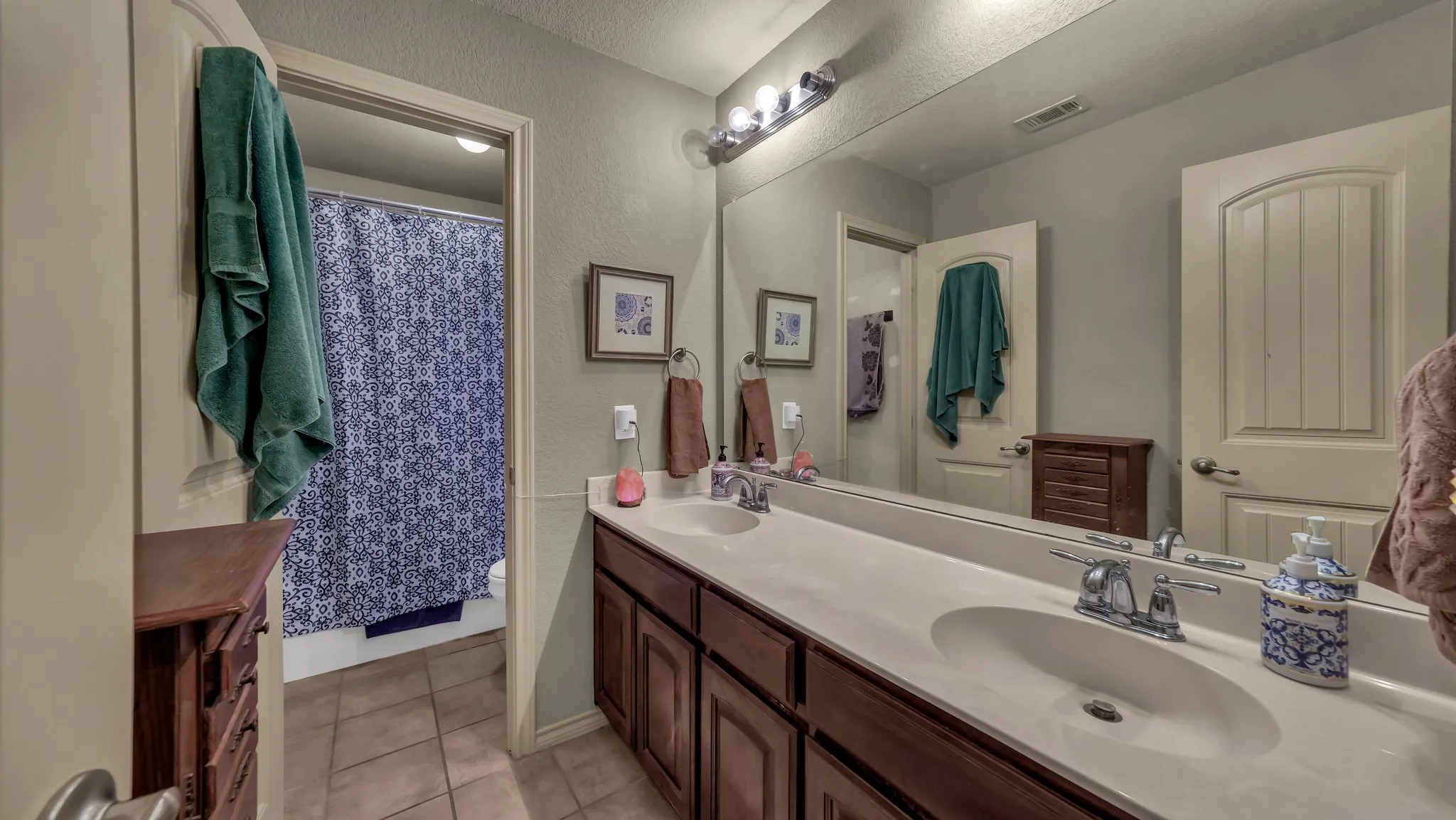 Double vanity featuring integrated sinks, chrome faucets, and an expansive countertop