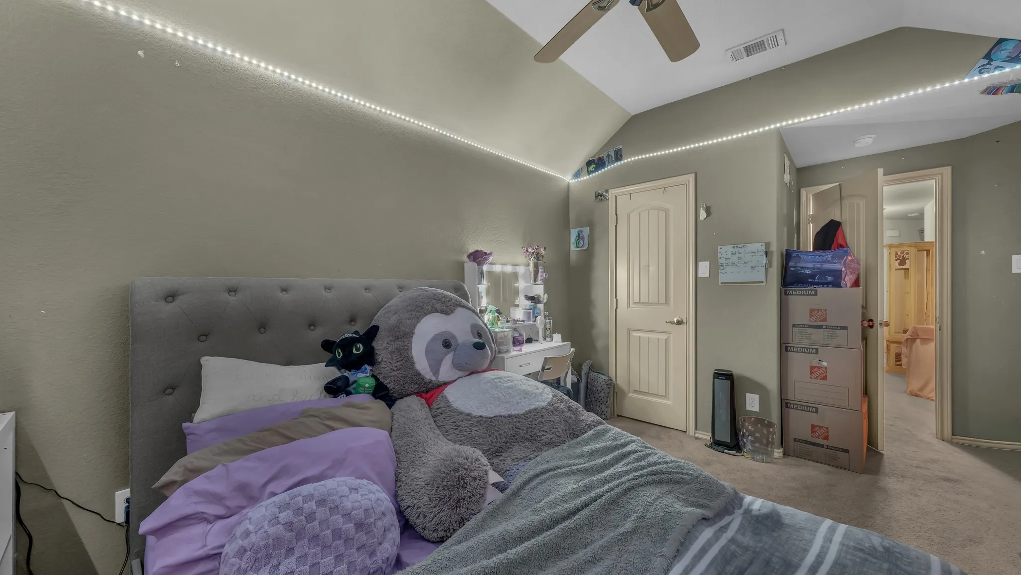 Carpeted room featuring a ceiling fan, recessed lighting, and a textured accent wall