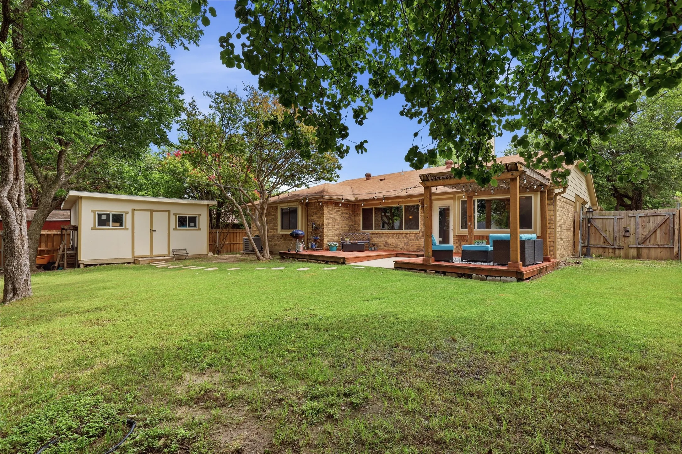 Expansive green lawn with a detached storage shed