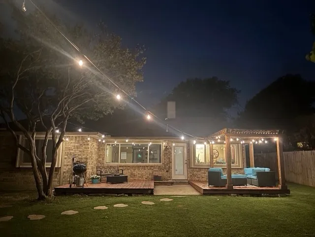 Expansive backyard featuring a manicured lawn and stone step paths