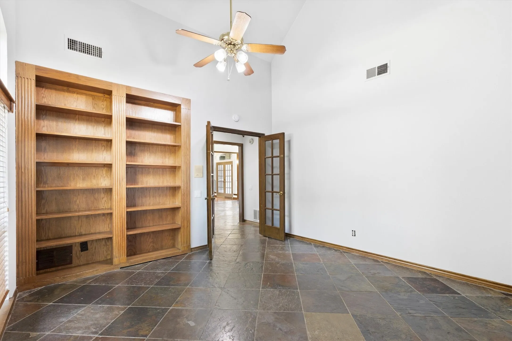Secondary bedroom with closet and natural light.  Making the walk-in closet behind the shelves.