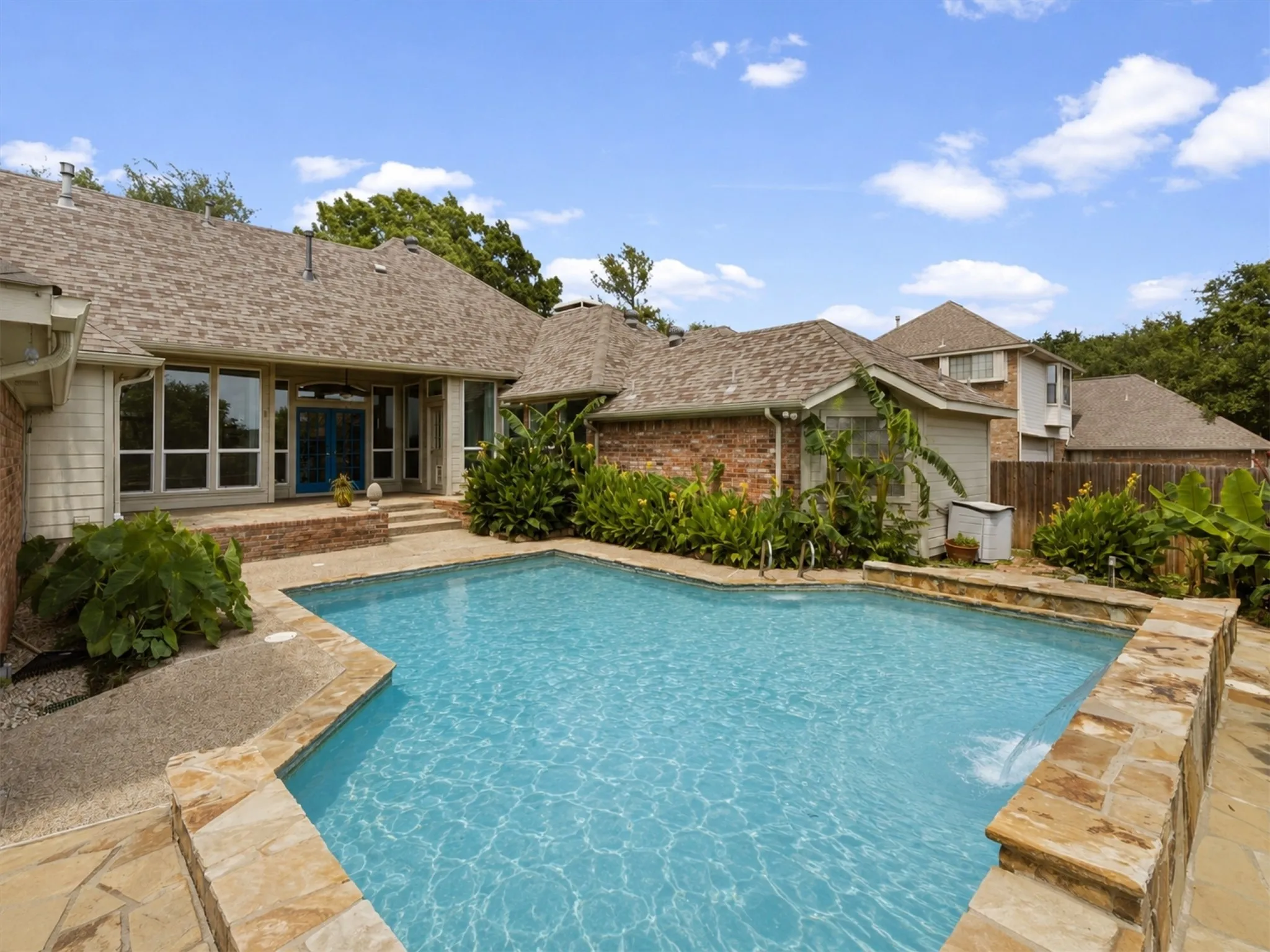 Enjoy a flowing waterfall during the day and a fully covered patio by night or day!