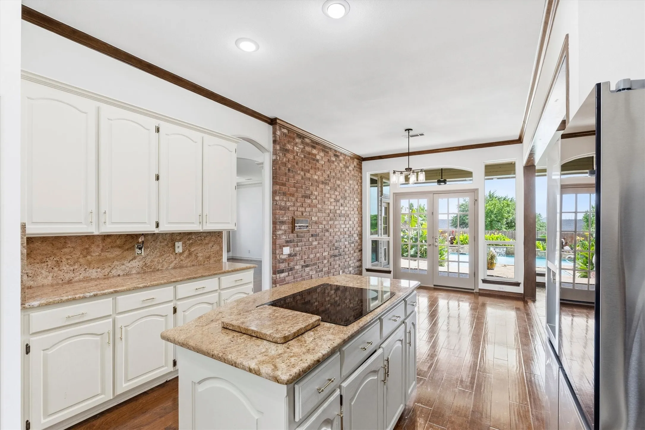 Freshly painted cabinetry, ample counter space, and views toward the backyard.