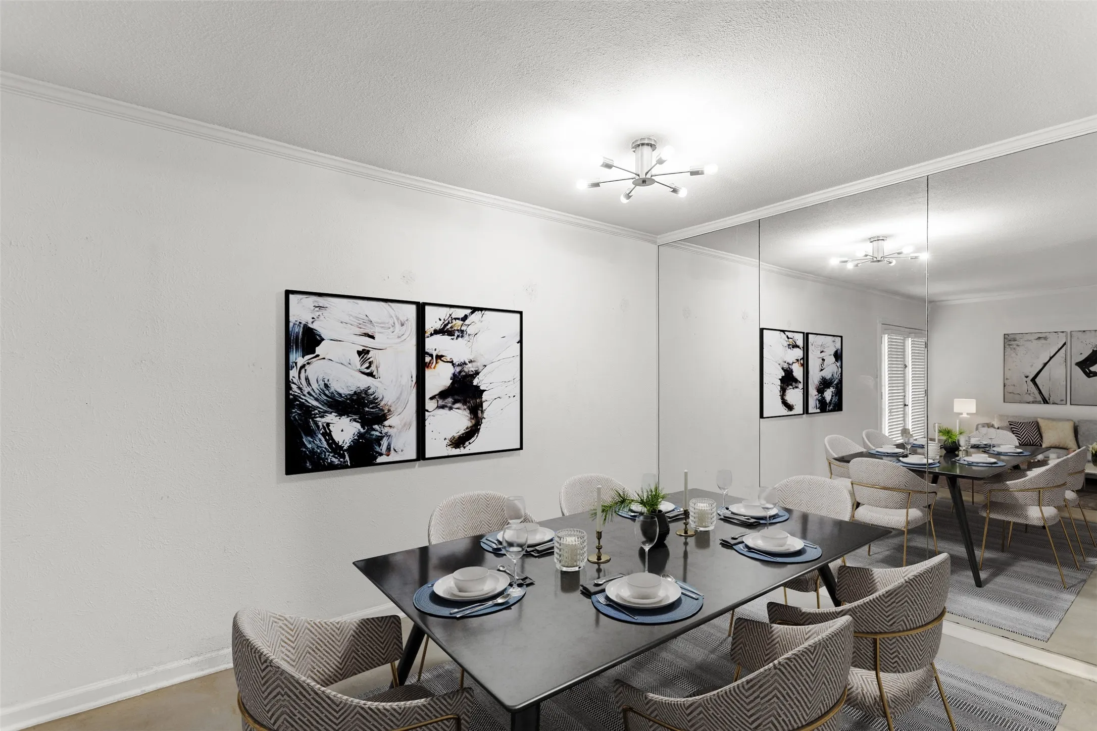 Virtually Staged Dining area featuring a modern light fixture, extensive mirrored wall, and crown molding
