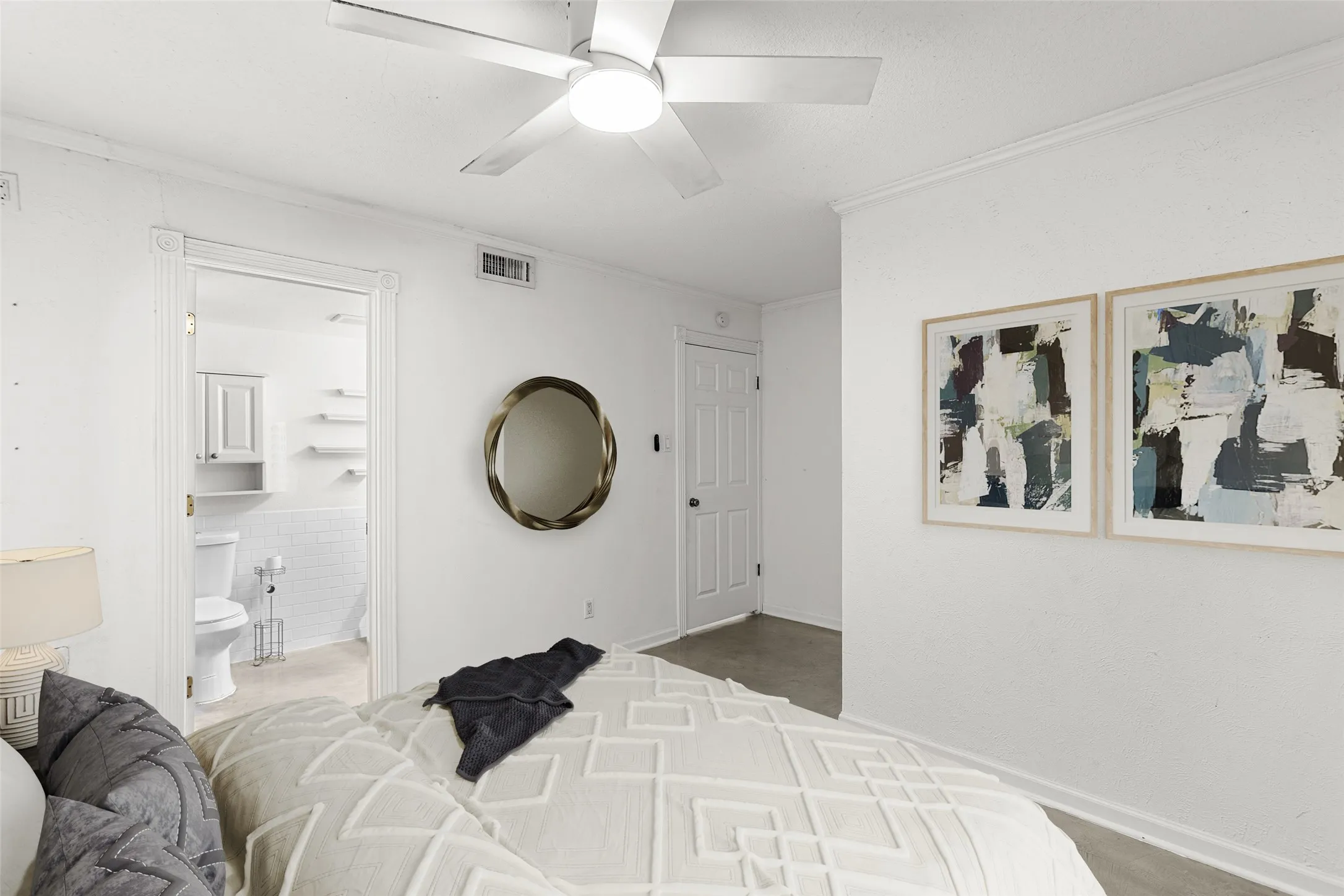 Virtually Staged Room featuring white walls, a ceiling fan with light, and a doorway opening to a bathroom with white subway tile