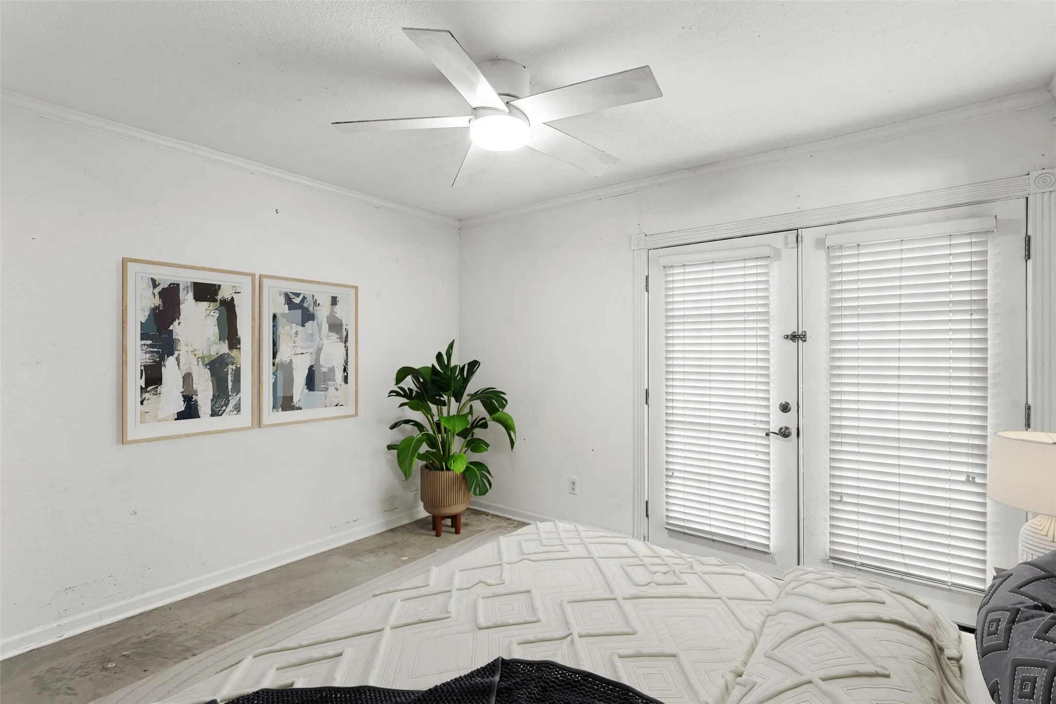 Virtually Staged Room featuring a ceiling fan with integrated lighting, crown molding, and double glass-paneled doors with blinds