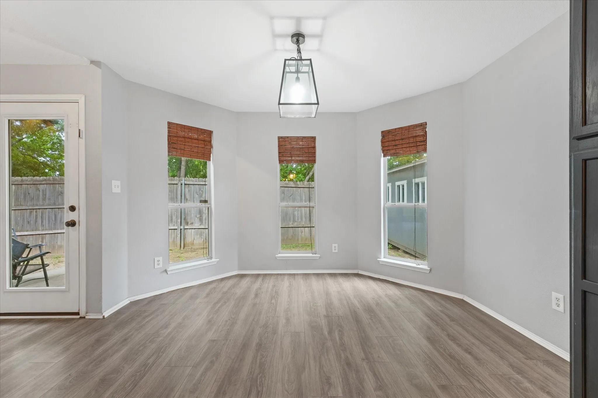 Bay window with three individual windows featuring woven blinds