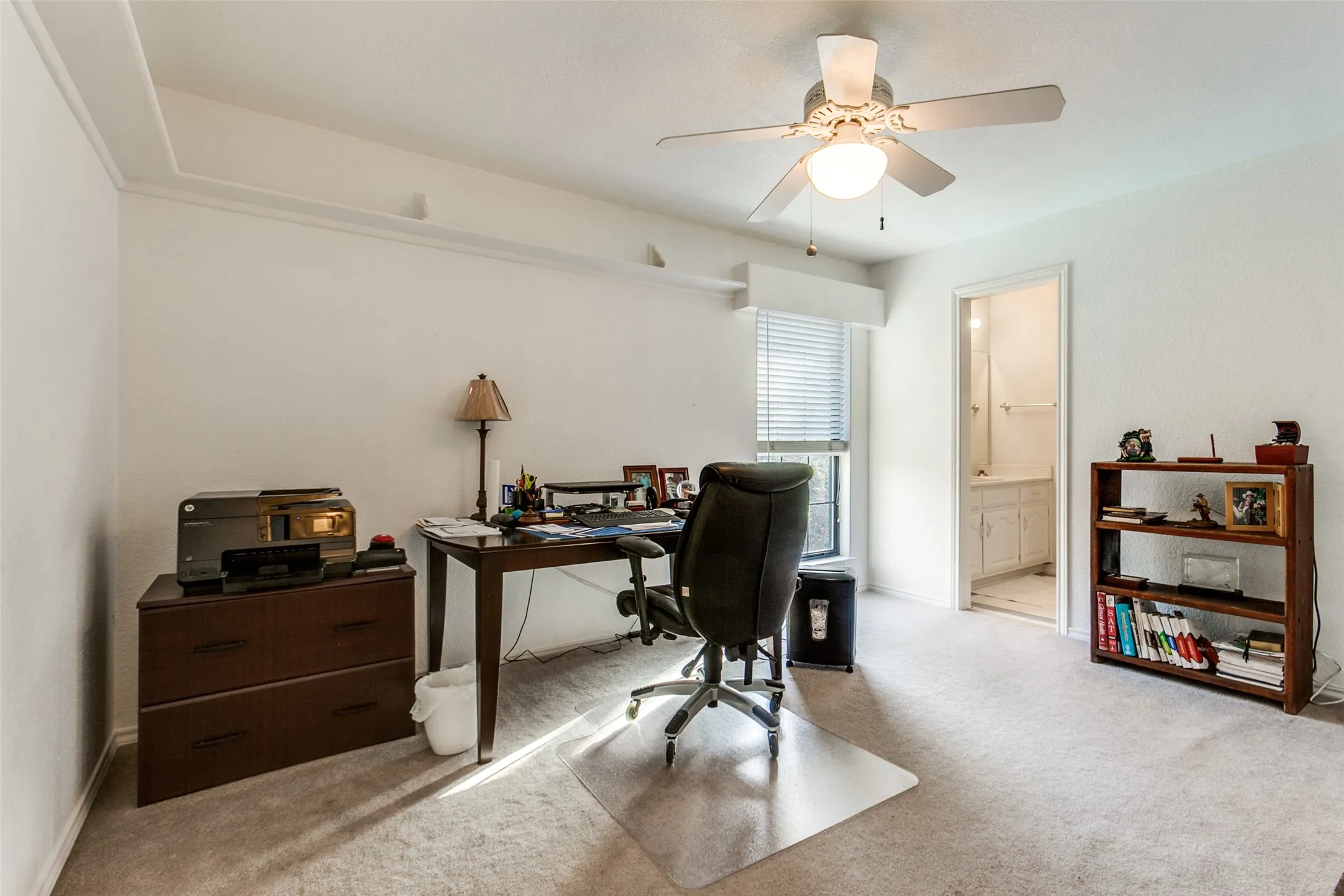 Carpeted room with a ceiling fan light fixture and crown molding