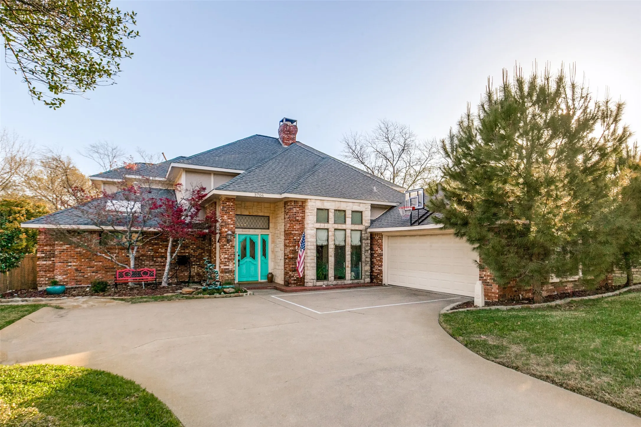 Traditional-style exterior featuring a multi-gabled roofline and a brick and stone facade