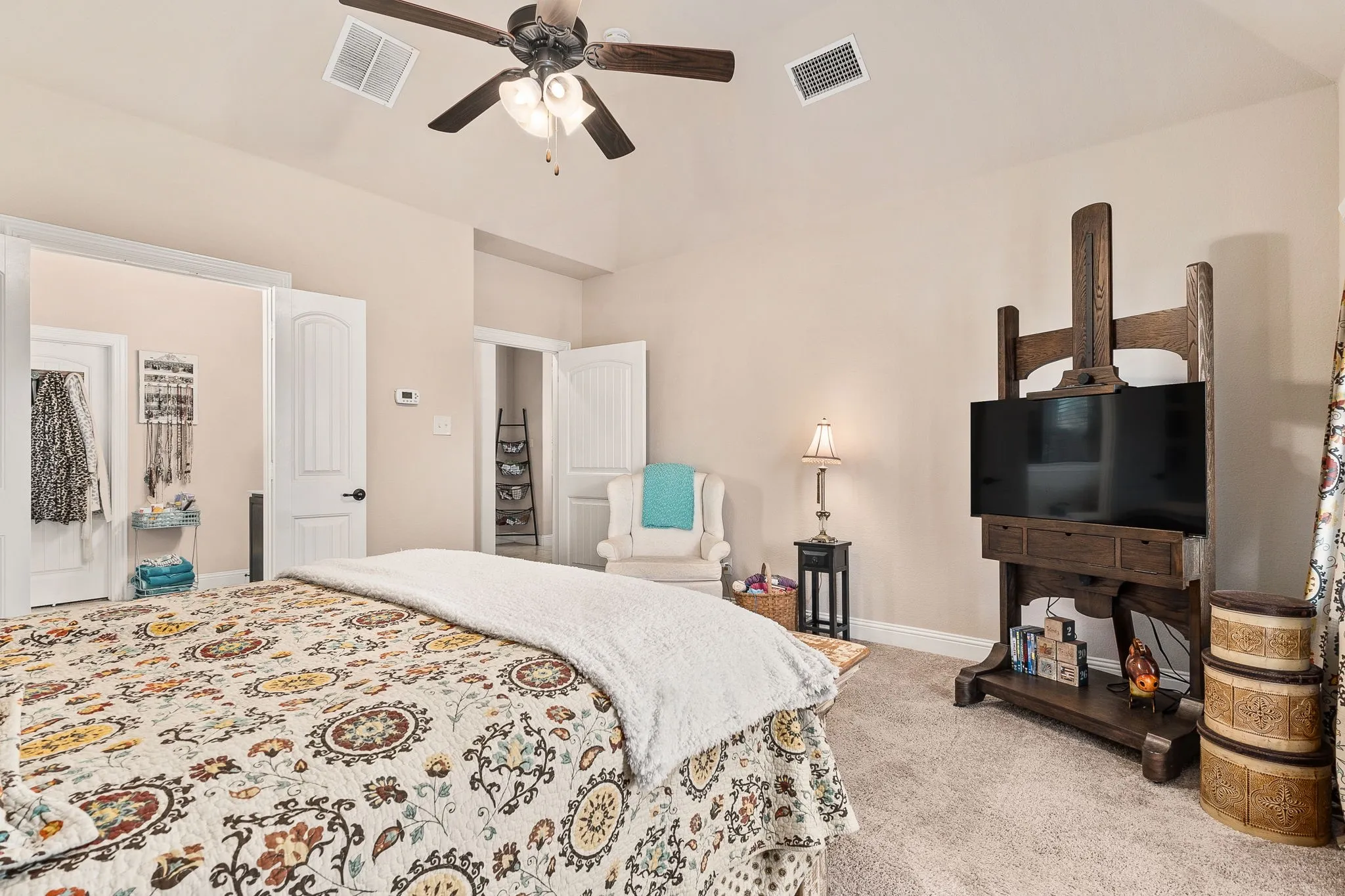 Carpeted bedroom with ceiling fan