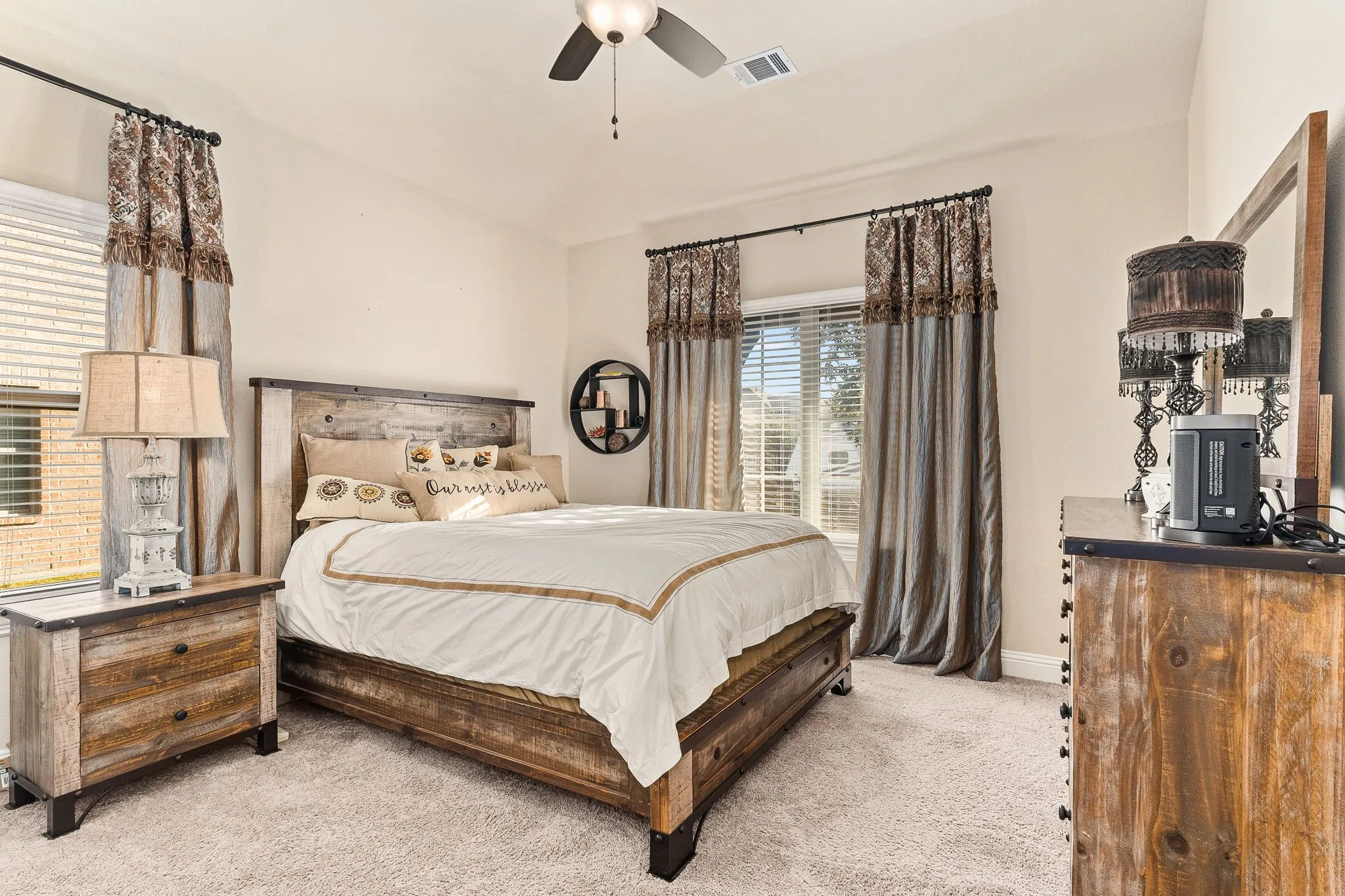 Bedroom featuring light colored carpet and ceiling fan