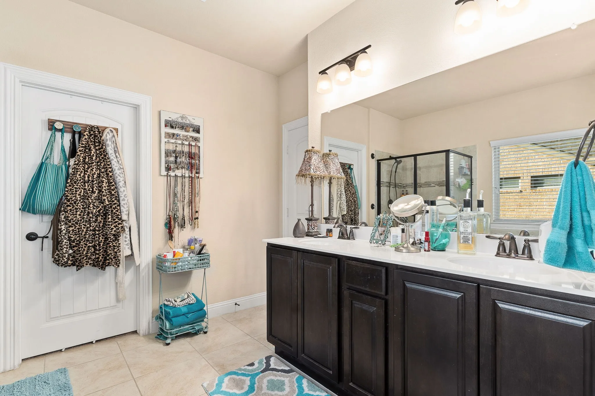 Bathroom featuring vanity, tile patterned floors, and a shower with shower door