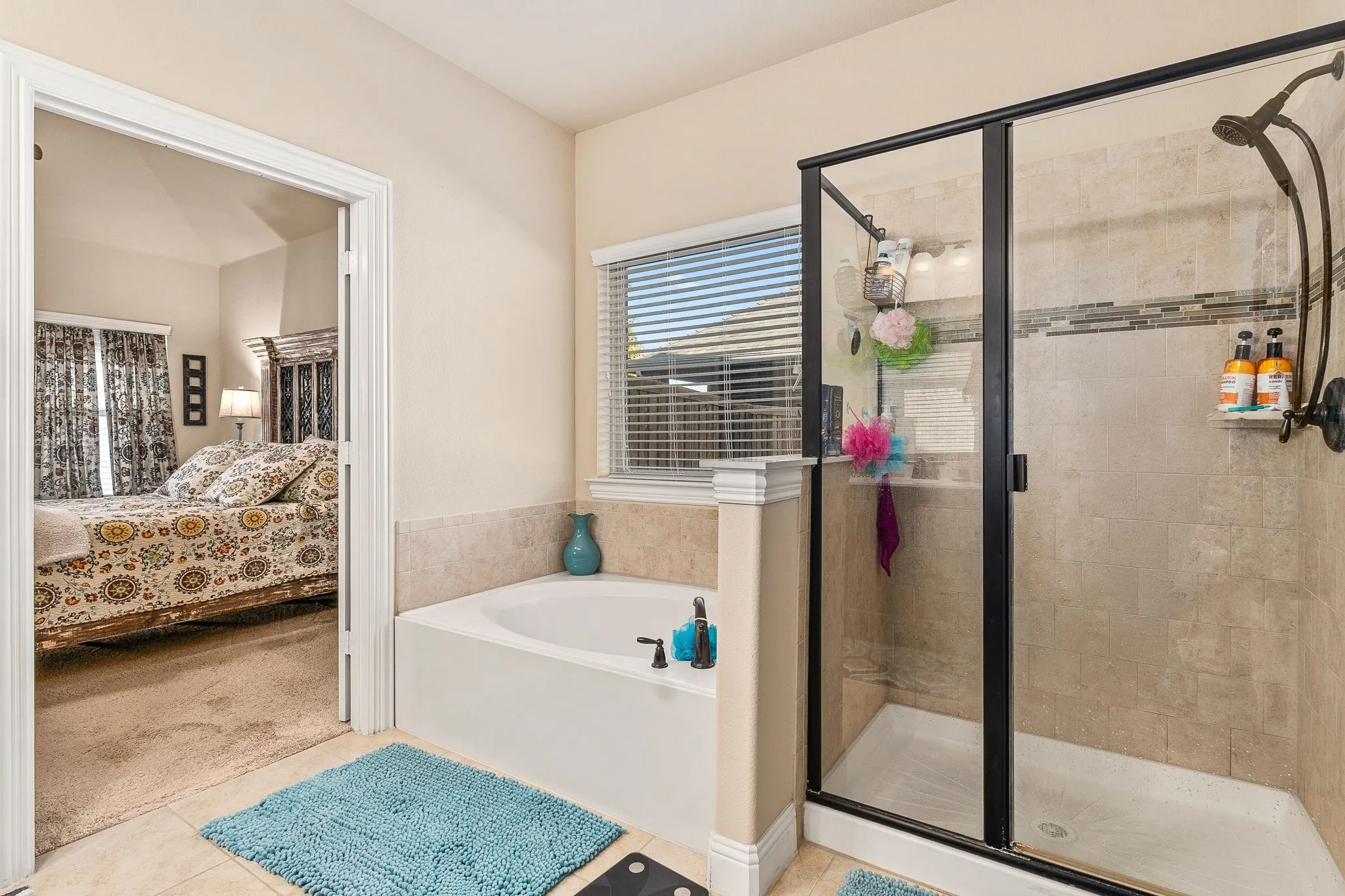 Bathroom with plus walk in shower and tile patterned flooring